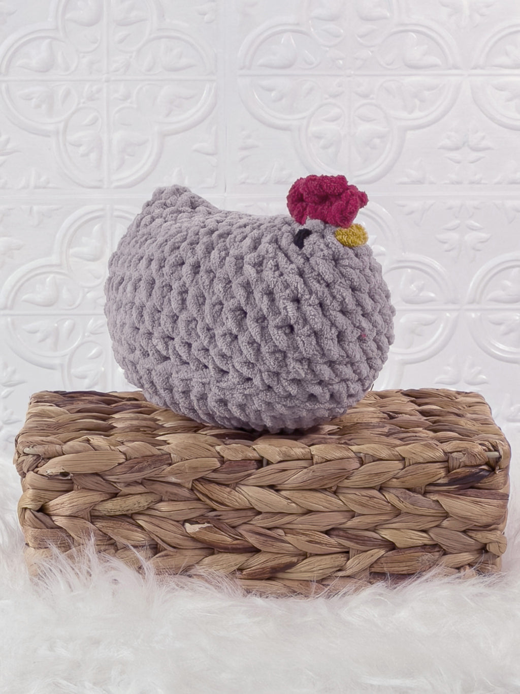 Handmade grey chicken crochet plushie shown from an angled view