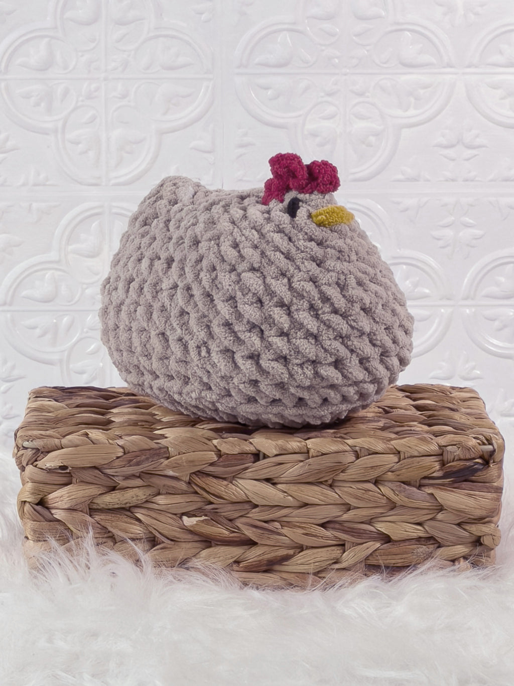 Handmade grey chicken crochet plushie shown from an angled view