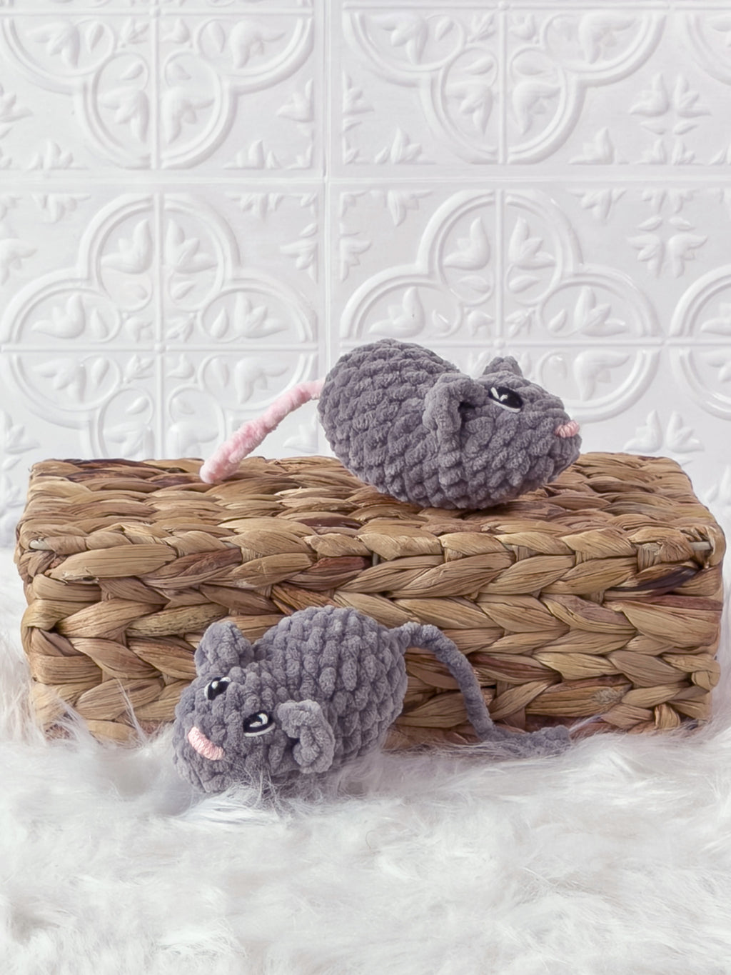 Handmade grey marnie the mouse crochet plushie shown from an angled view