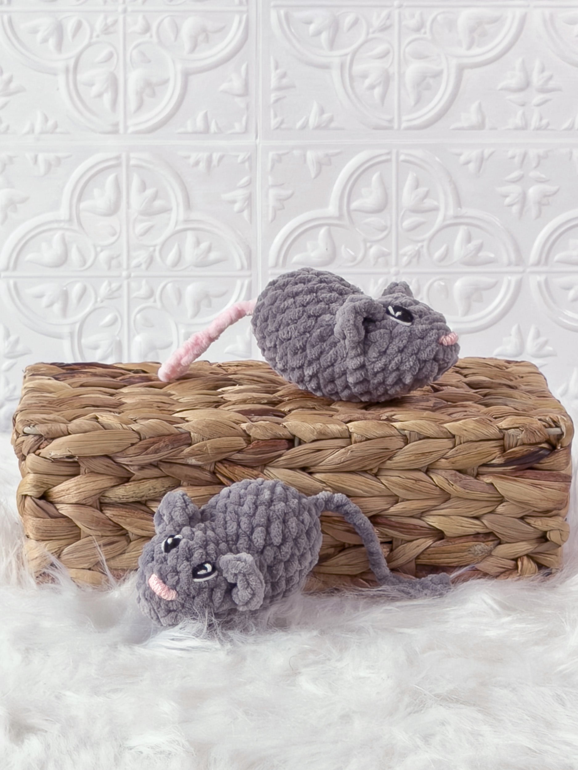 Handmade grey marnie the mouse crochet plushie shown from an angled view