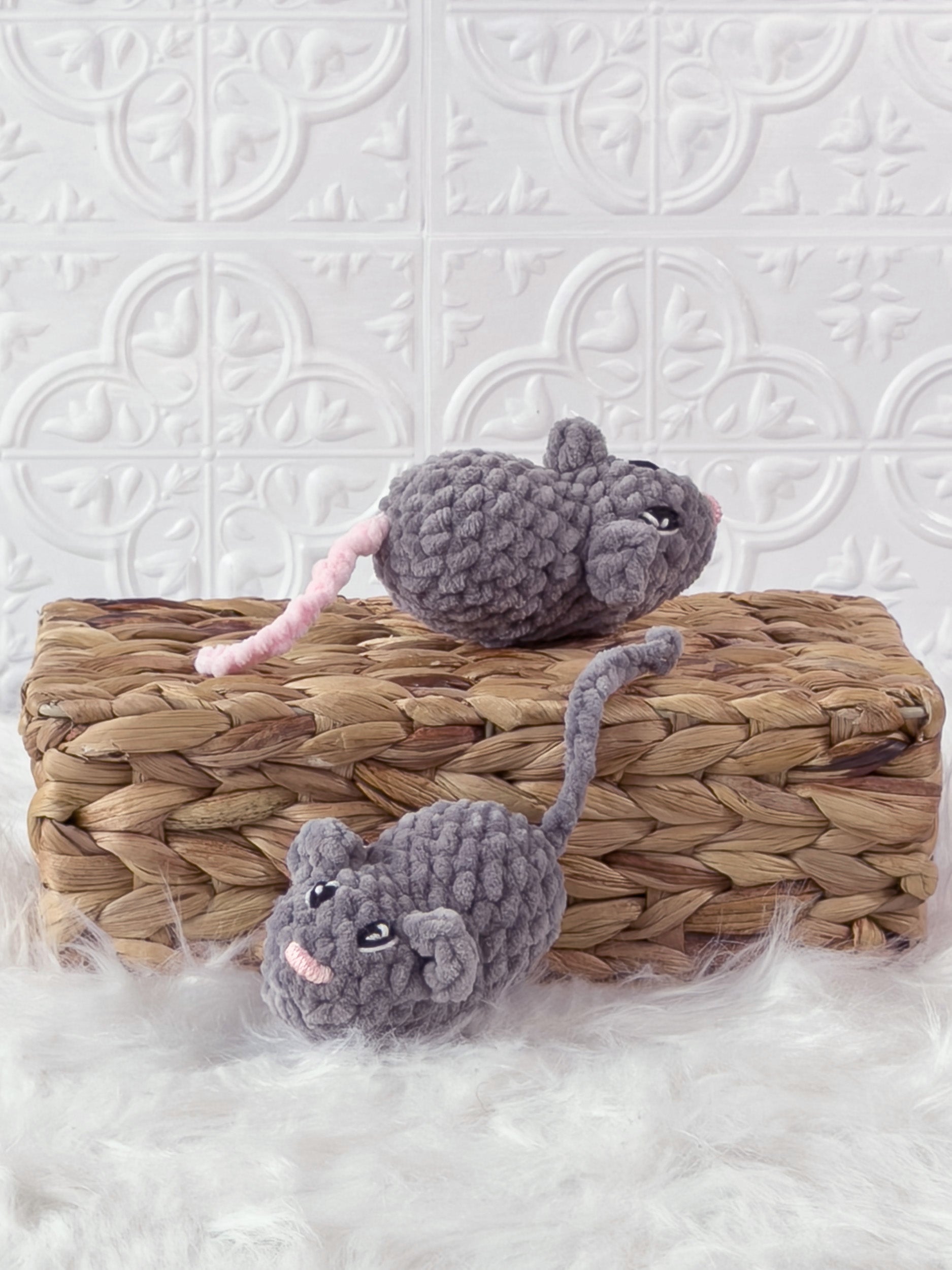 Handmade grey marnie the mouse crochet plushie shown from the back