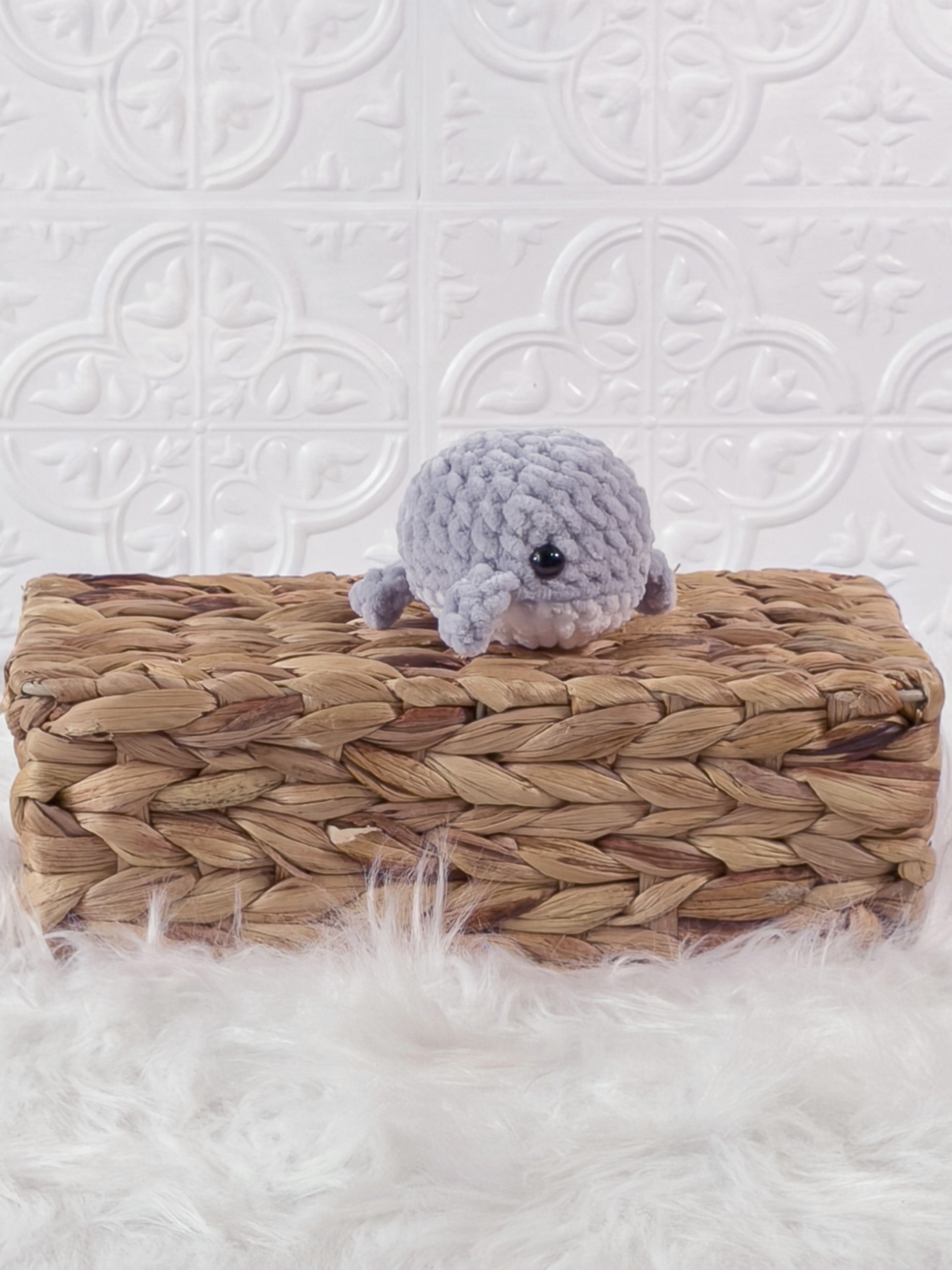 Small handmade whale crochet plushie shown from the front