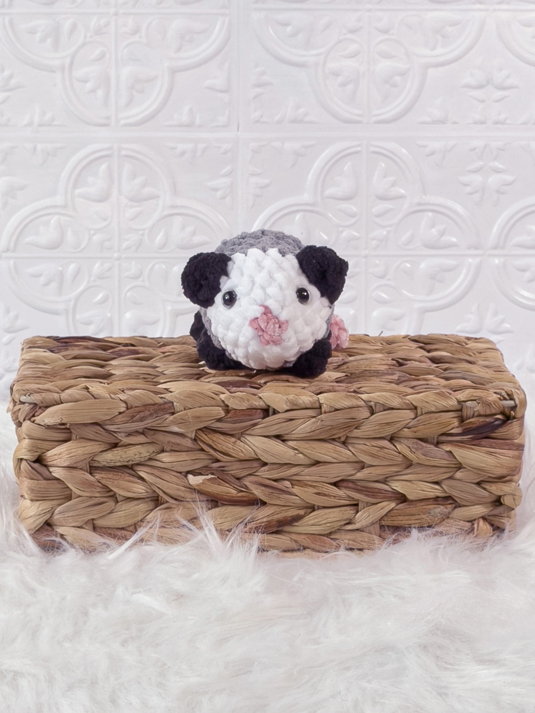 Handmade grey opossum crochet plushie shown from the front