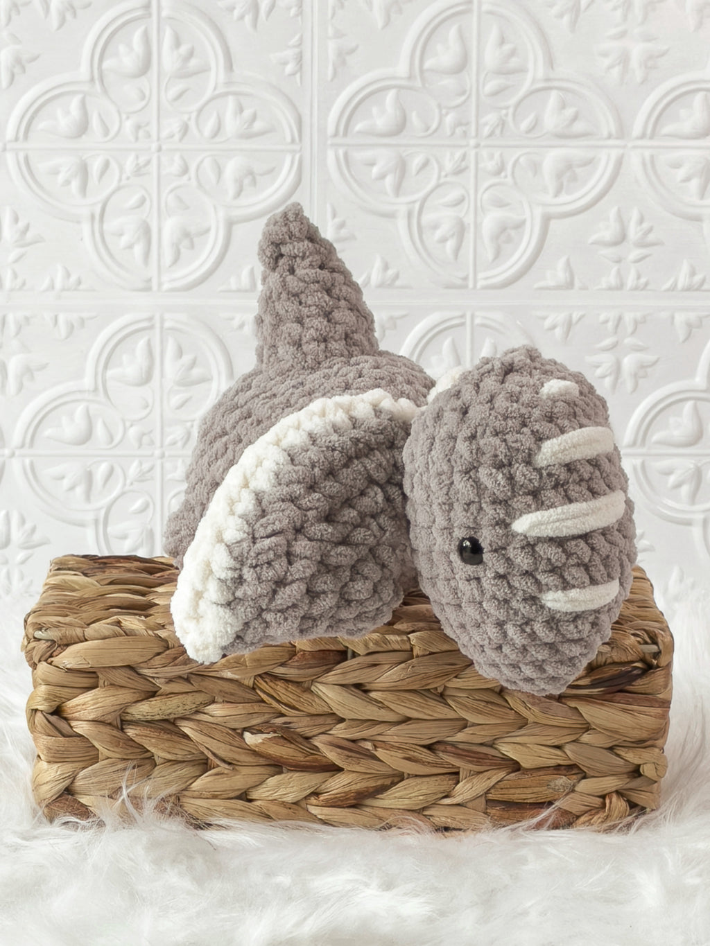Handmade grey pterodactyl crochet plushie shown in a product image