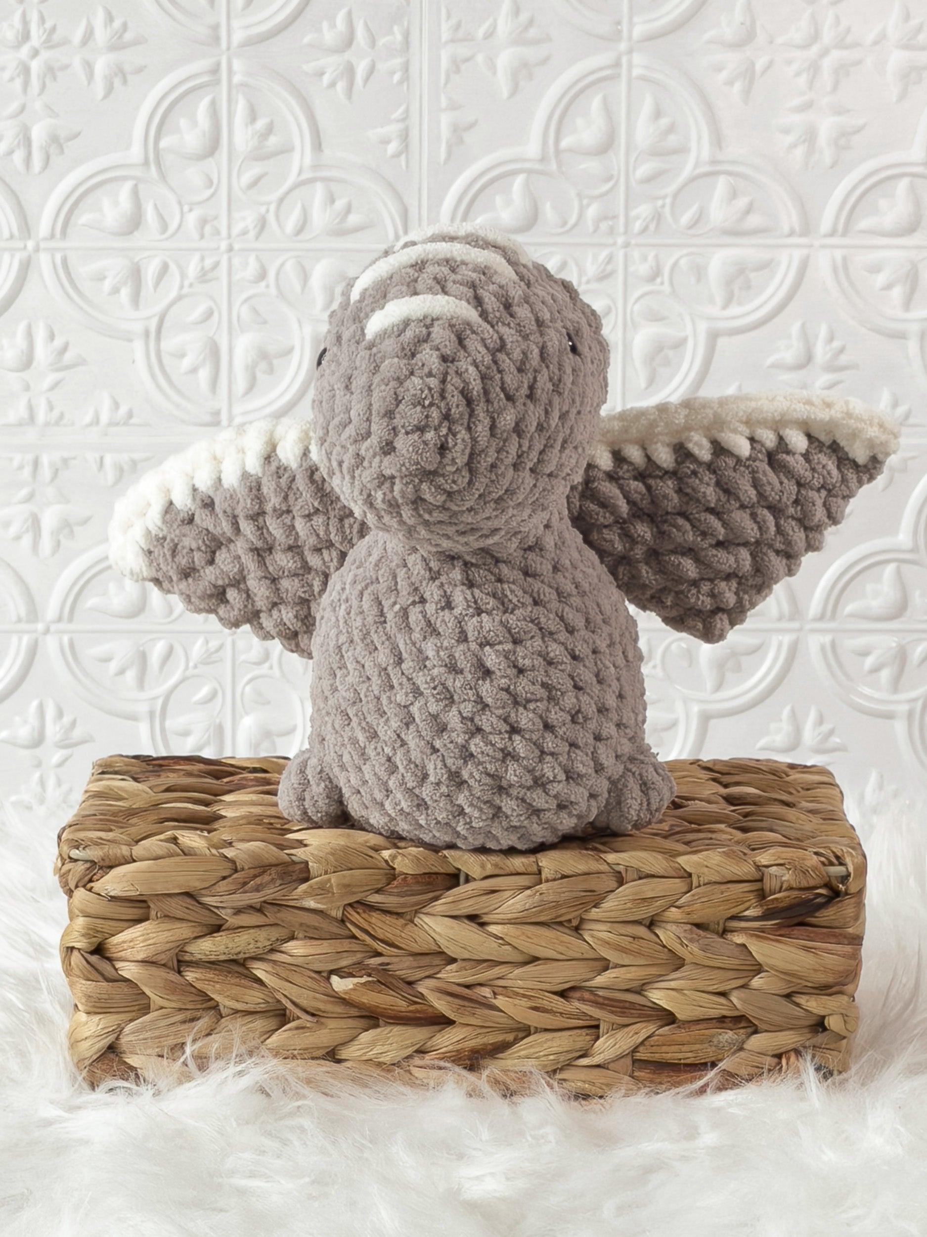 Handmade grey pterodactyl crochet plushie shown from the front