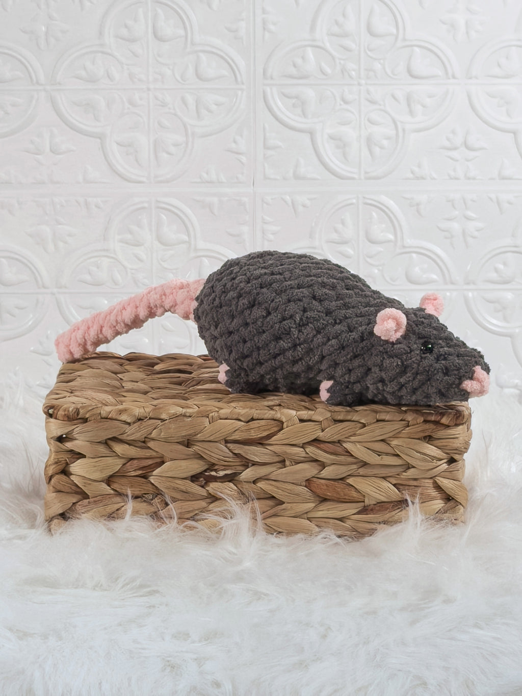 Handmade grey rat crochet plushie shown from an angled view