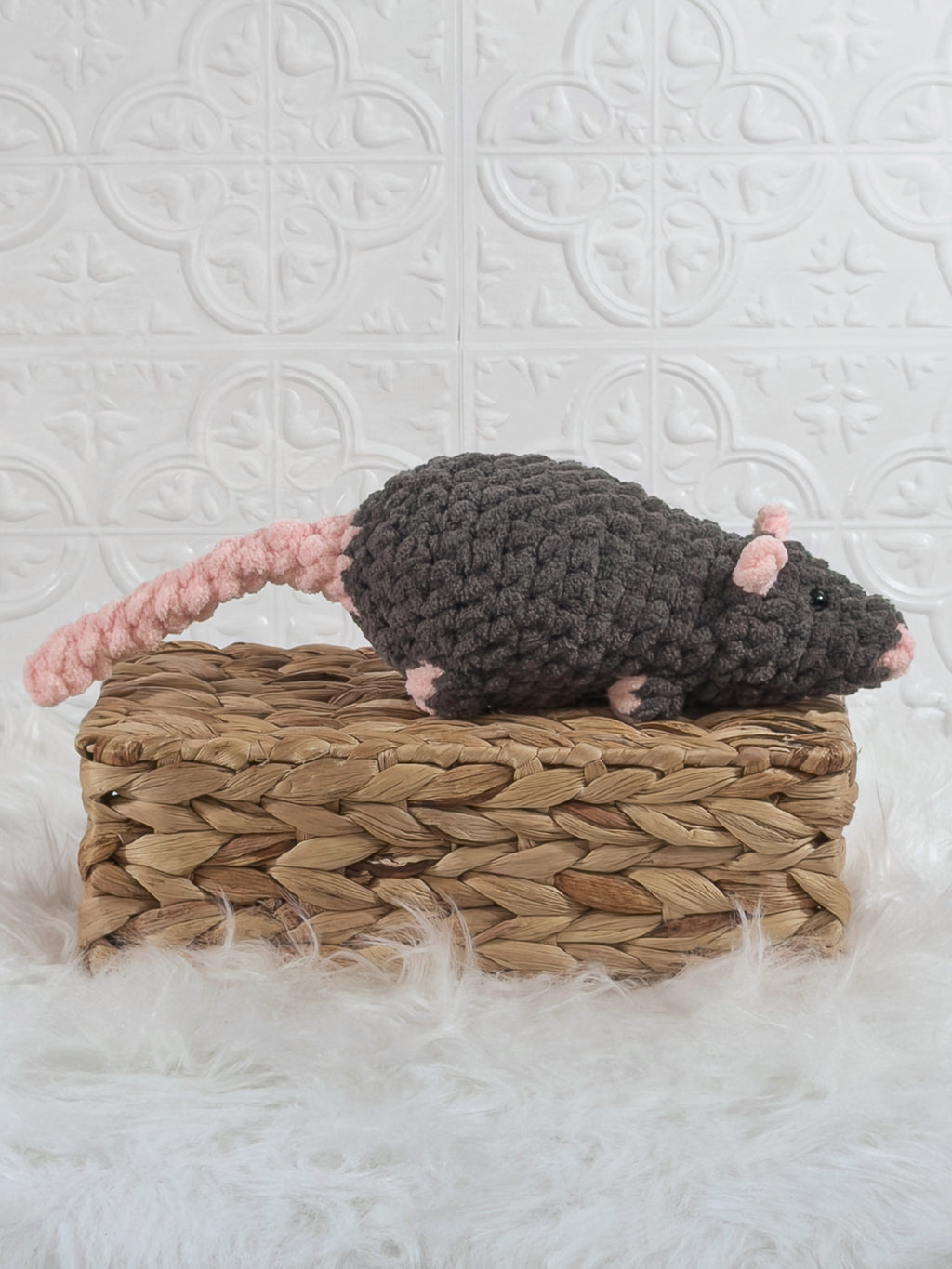 Handmade grey rat crochet plushie shown from the side