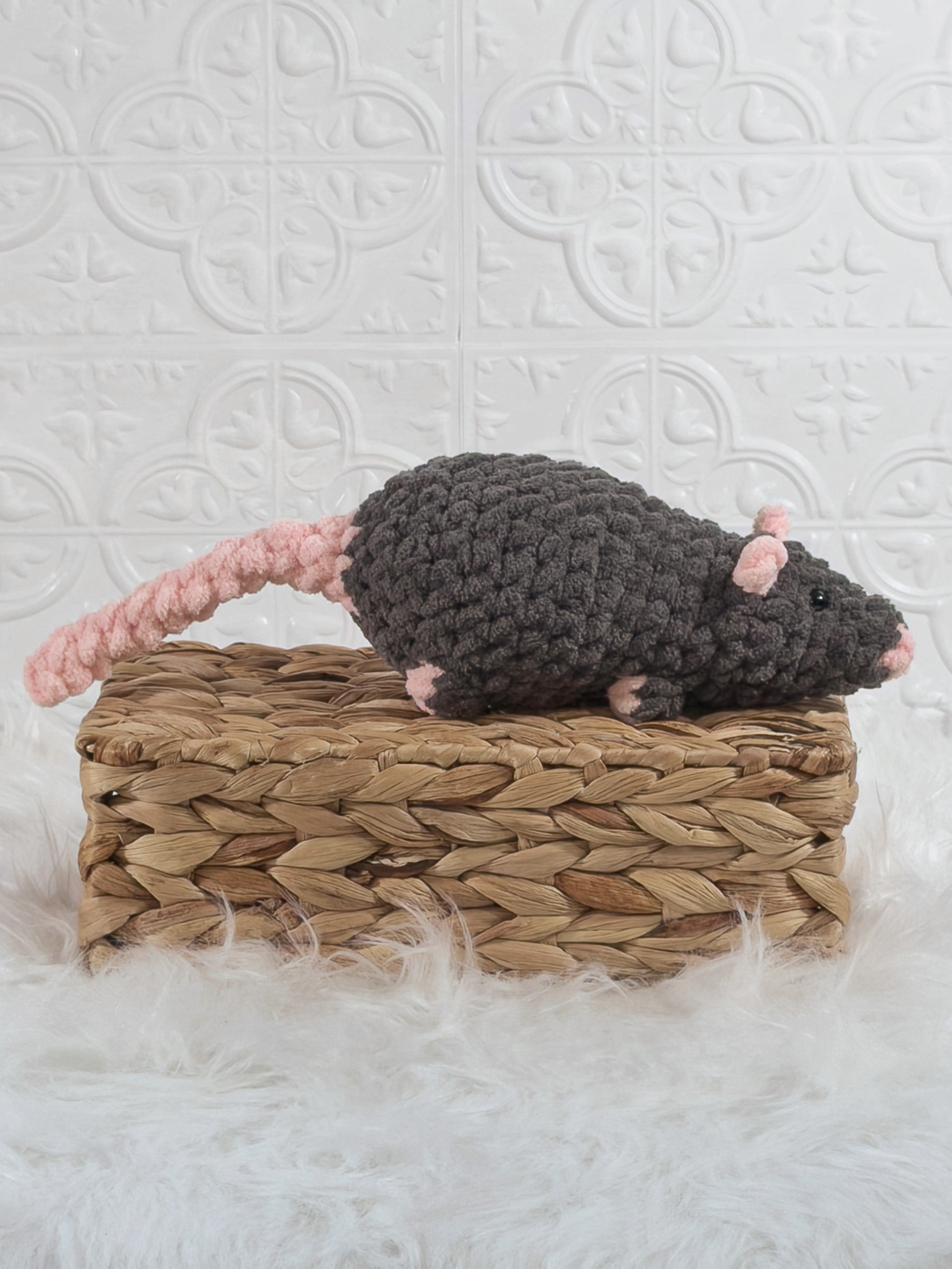 Handmade grey rat crochet plushie shown from the side