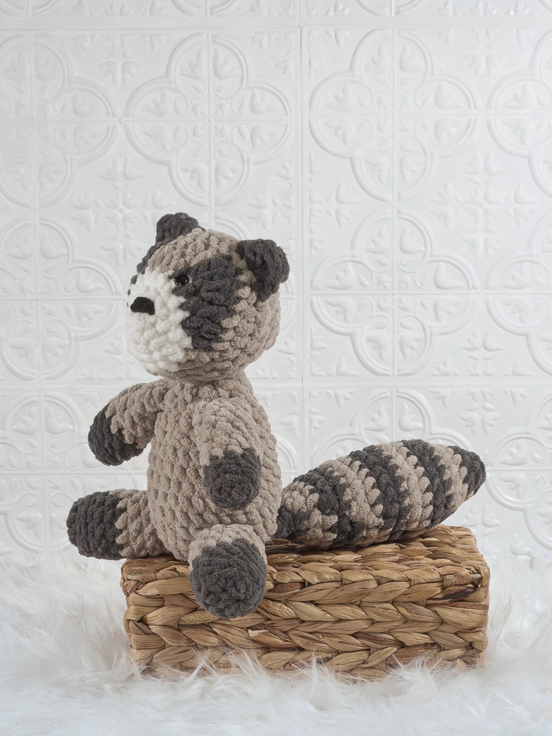 Handmade raccoon crochet plushie shown from the front