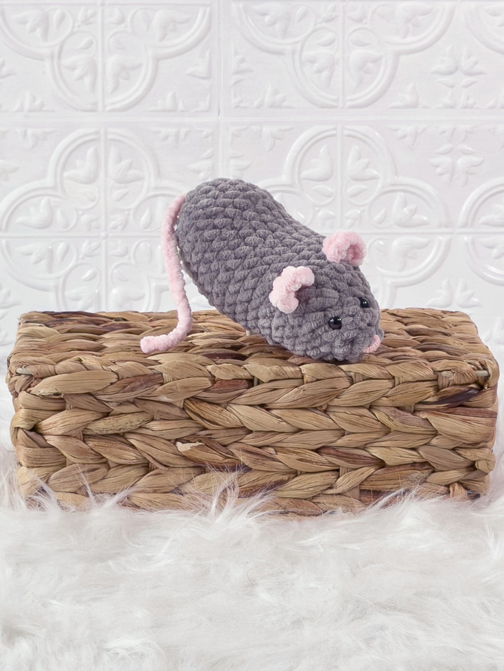 Handmade grey, dark mouse crochet plushie shown from an angled view