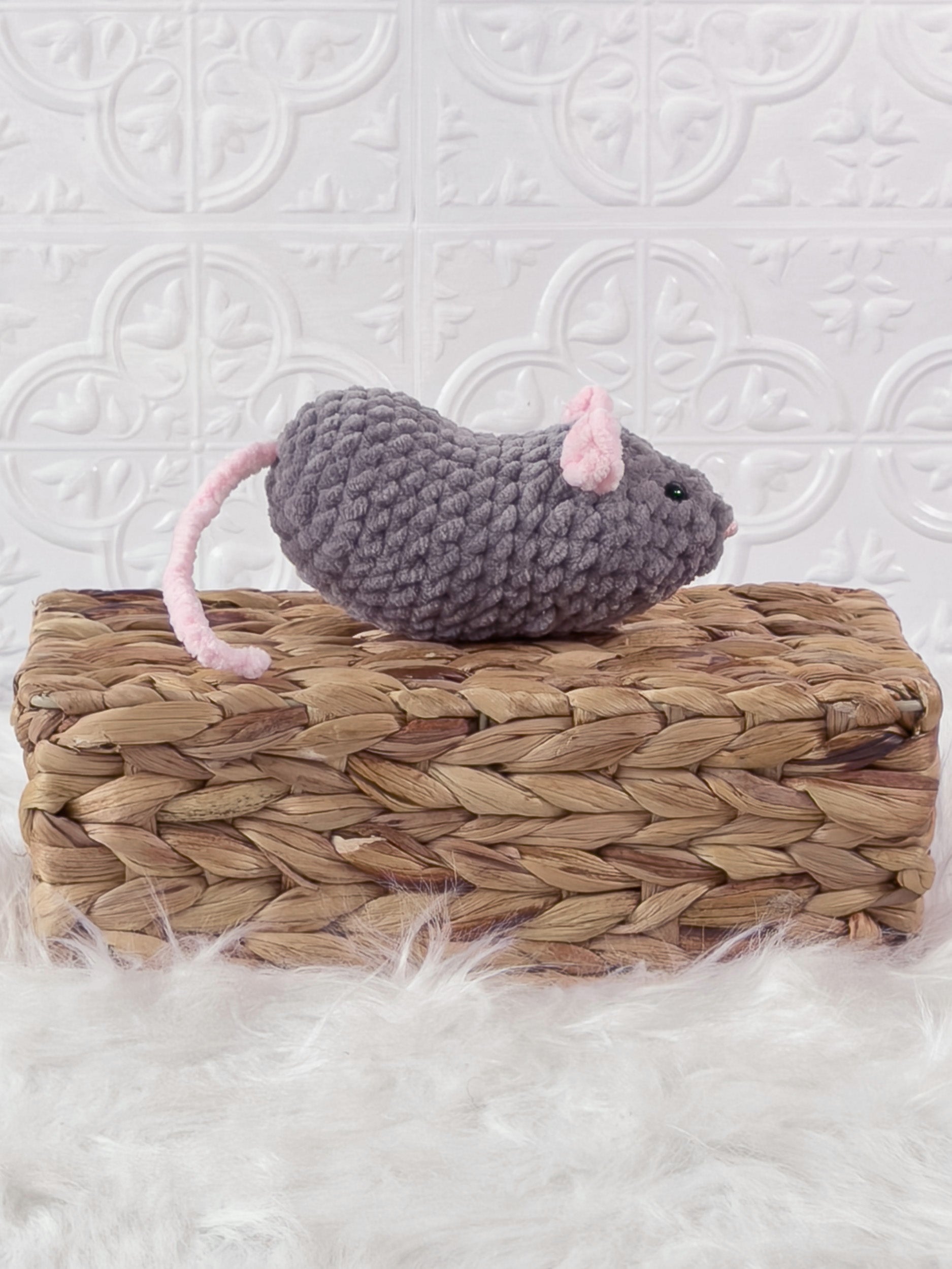 Handmade grey, dark mouse crochet plushie shown from the side