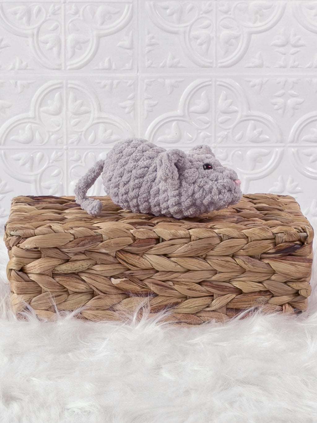 Handmade grey, light mouse crochet plushie shown from an angled view