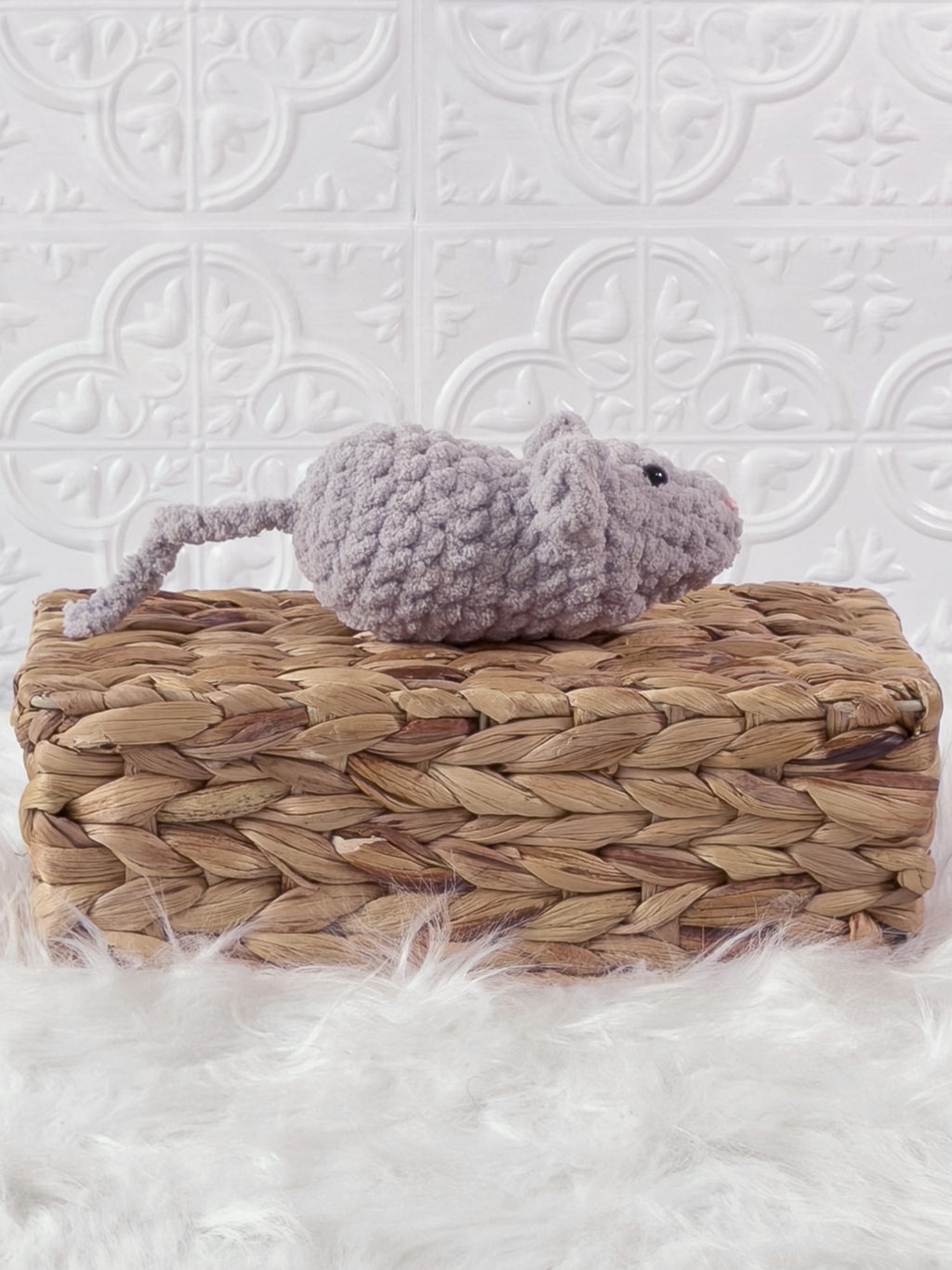 Handmade grey, light mouse crochet plushie shown from the side