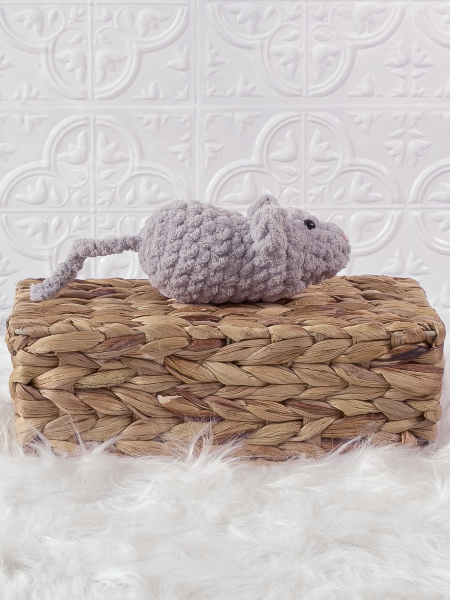 Handmade grey, light mouse crochet plushie shown from the side