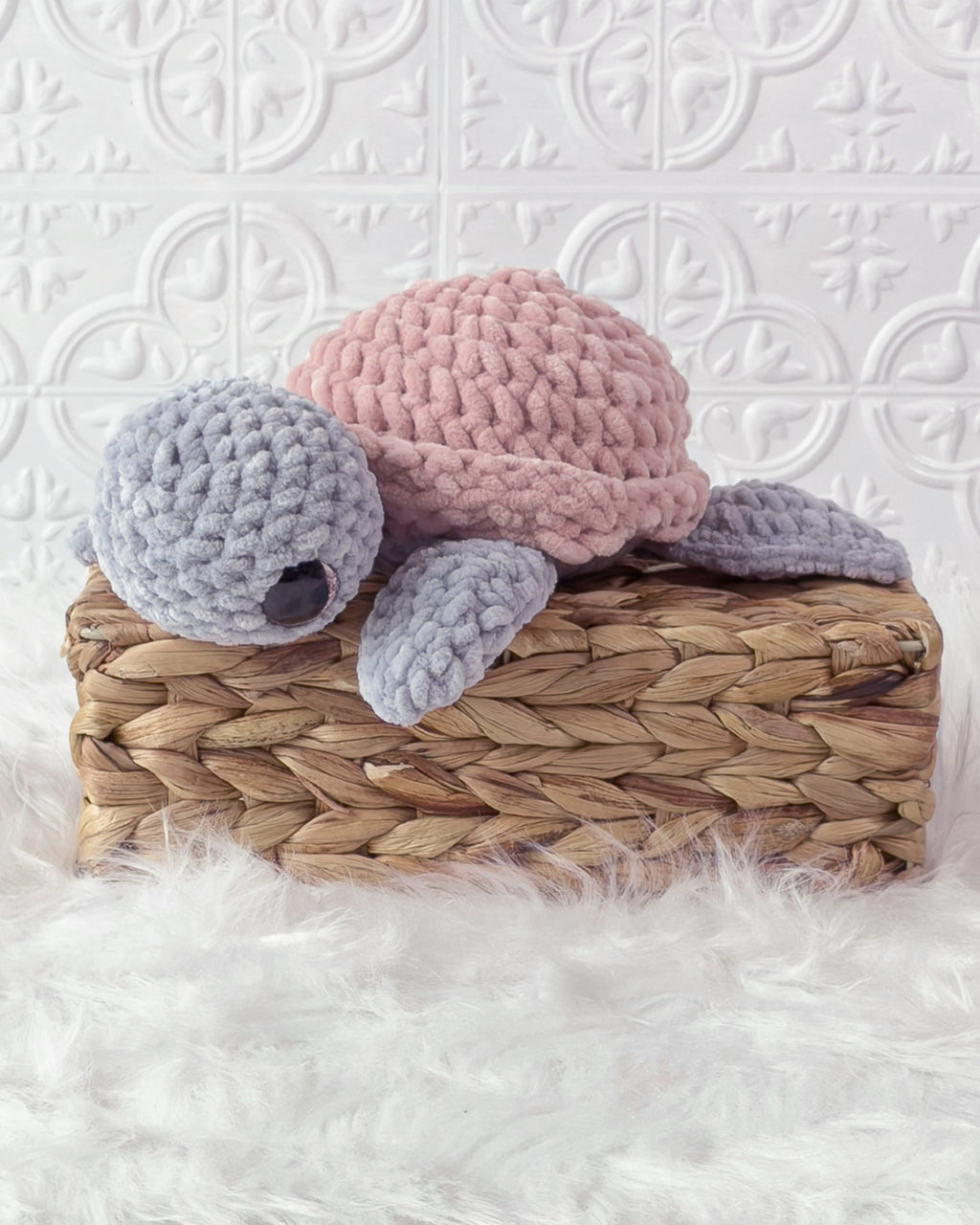 Handmade grey, pink turtle crochet plushie shown from the front