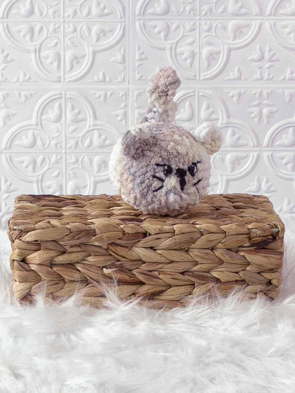 Handmade multicolor angry cat crochet plushie shown from an angled view