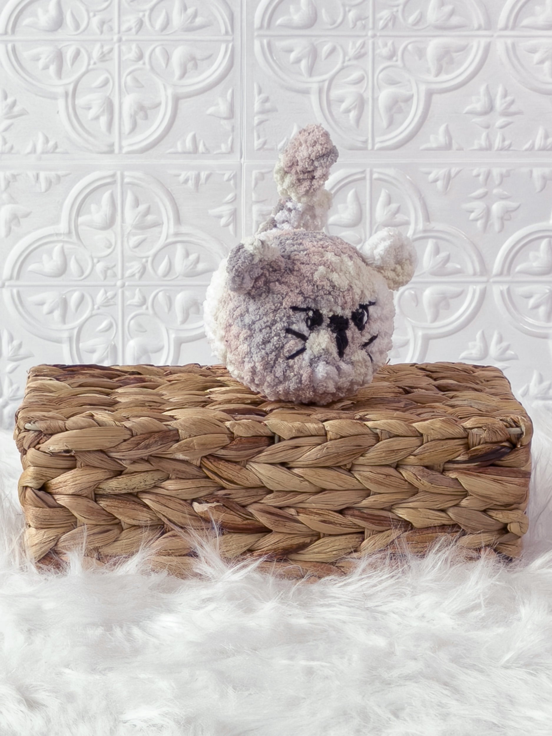 Handmade multicolor angry cat crochet plushie shown from an angled view