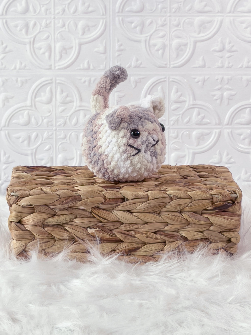 Handmade multicolor kitten crochet plushie shown from an angled view