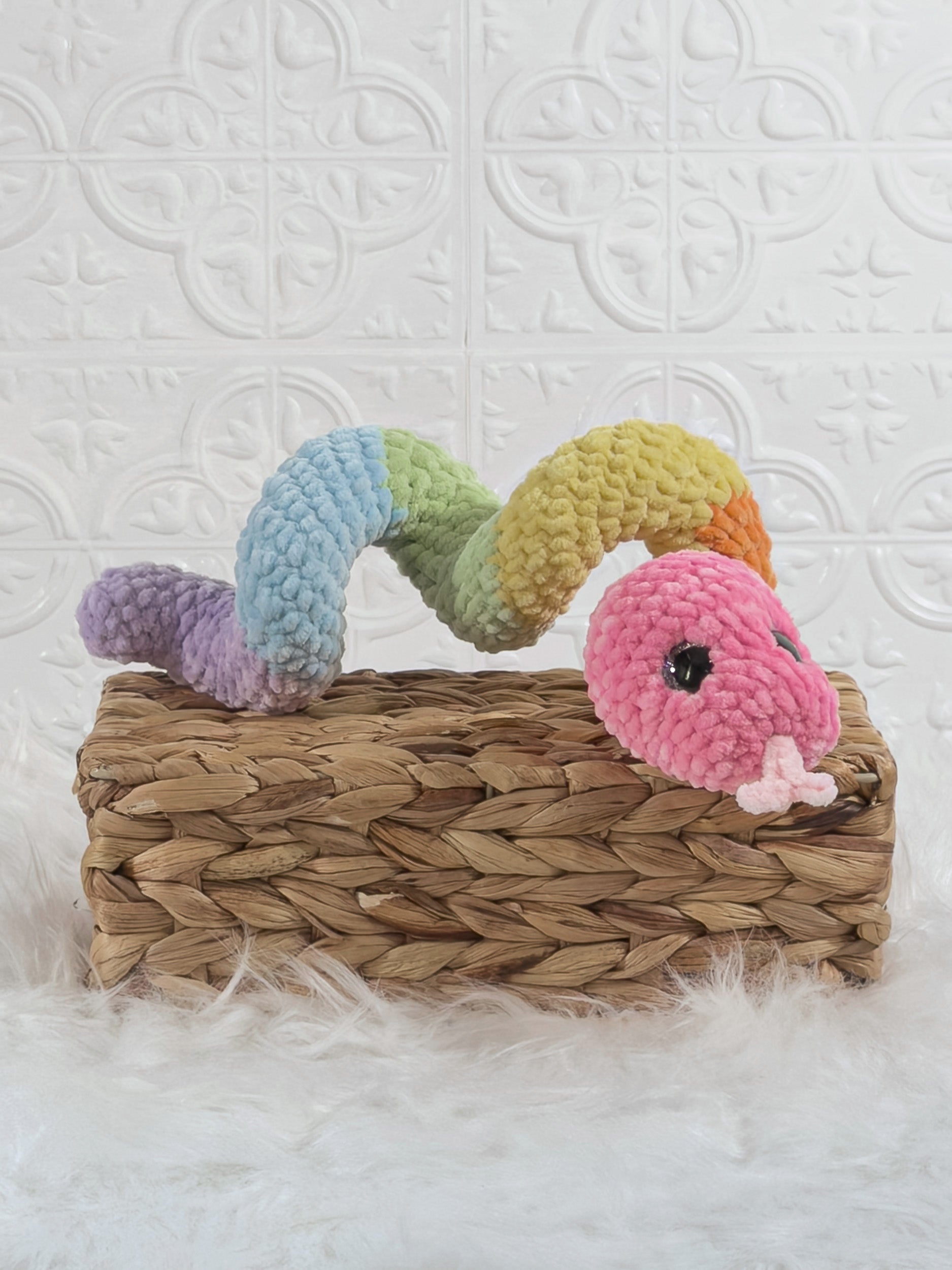 Handmade multicolor snake crochet plushie shown from an angled view