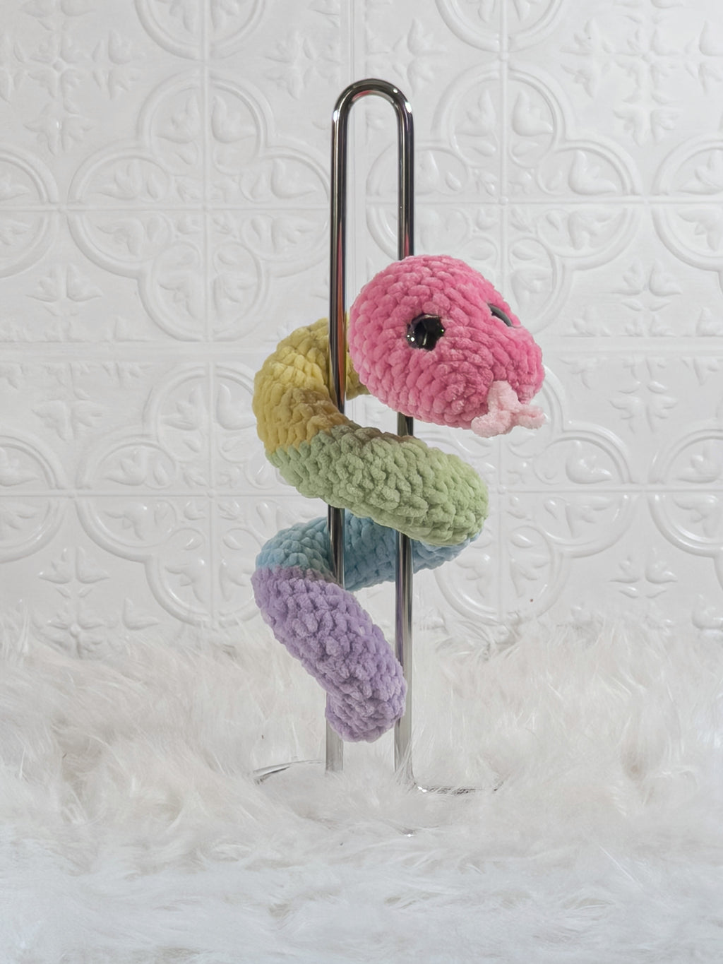 Handmade multicolor snake crochet plushie shown from the back