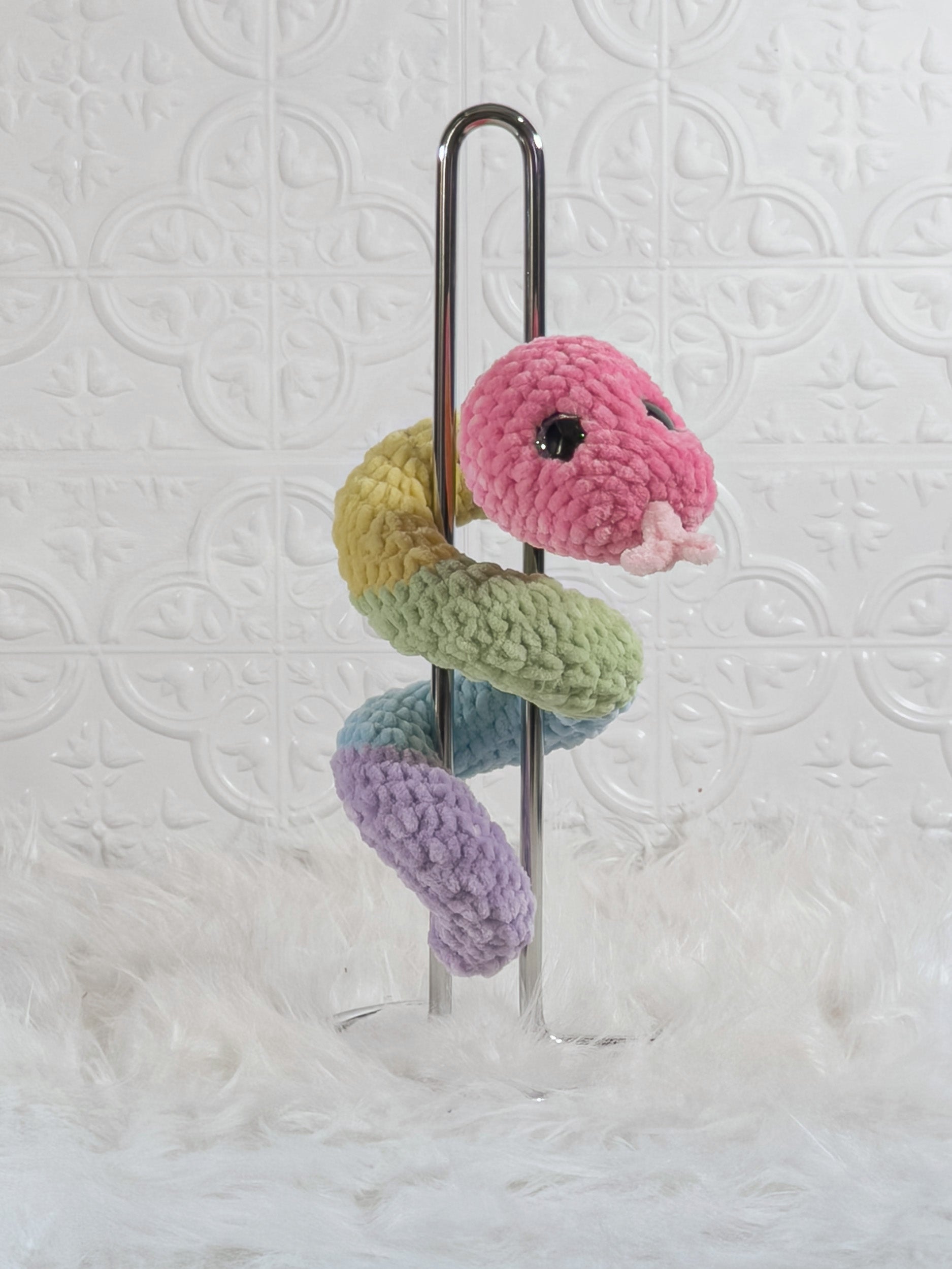 Handmade multicolor snake crochet plushie shown from the back
