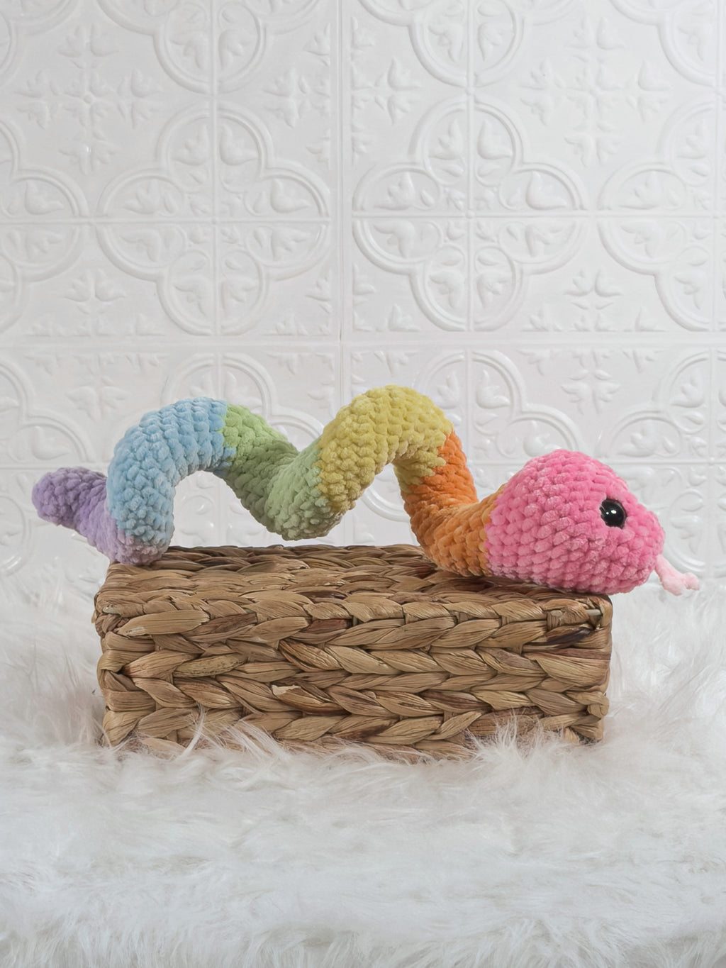 Handmade multicolor snake crochet plushie shown from the side