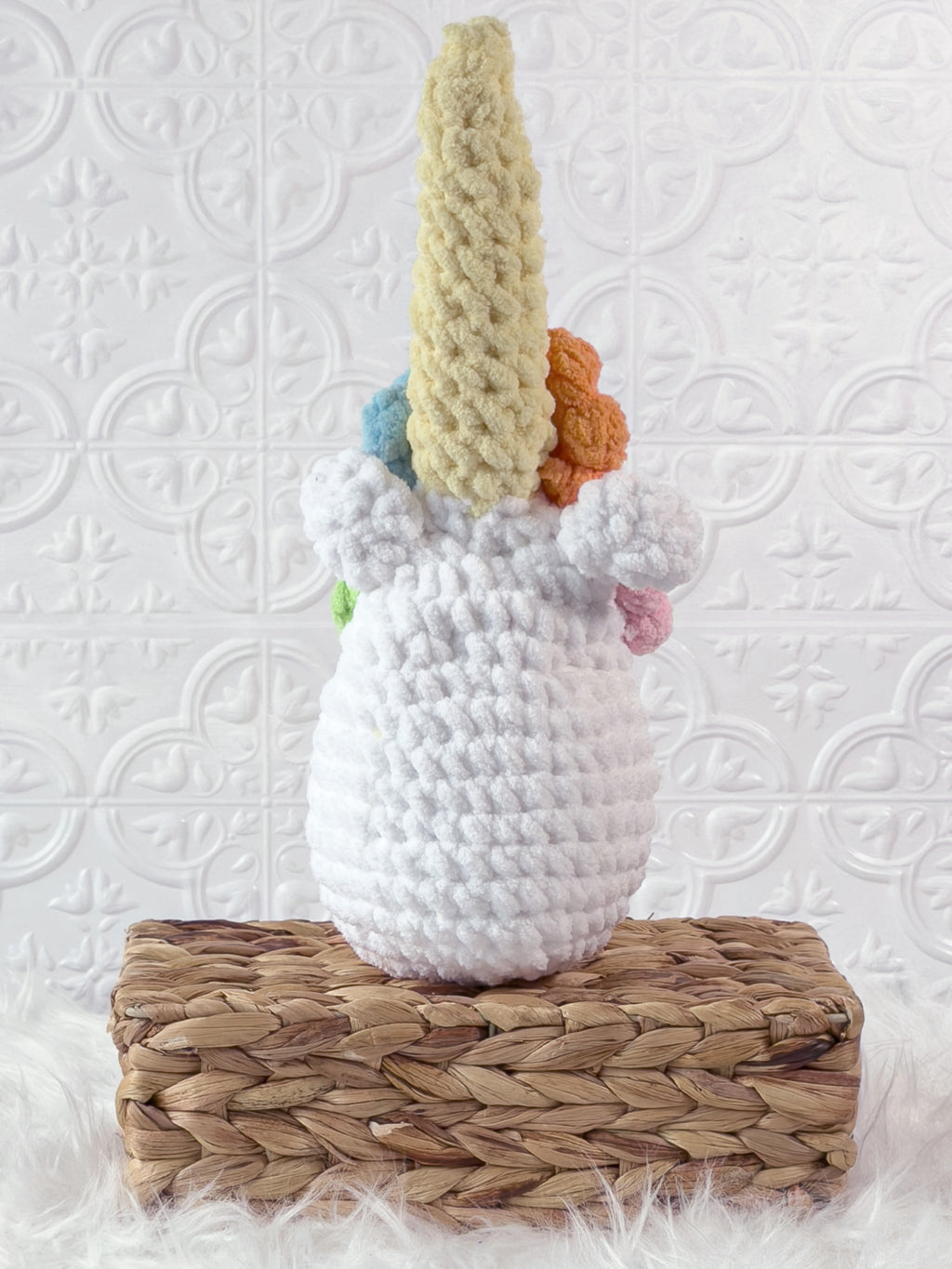 Handmade multicolor unicorn crochet plushie shown from the back