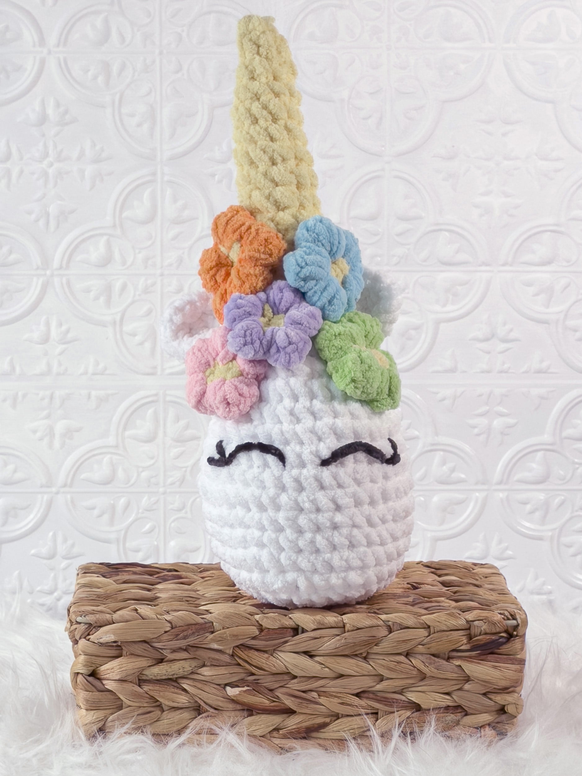 Handmade multicolor unicorn crochet plushie shown from the front