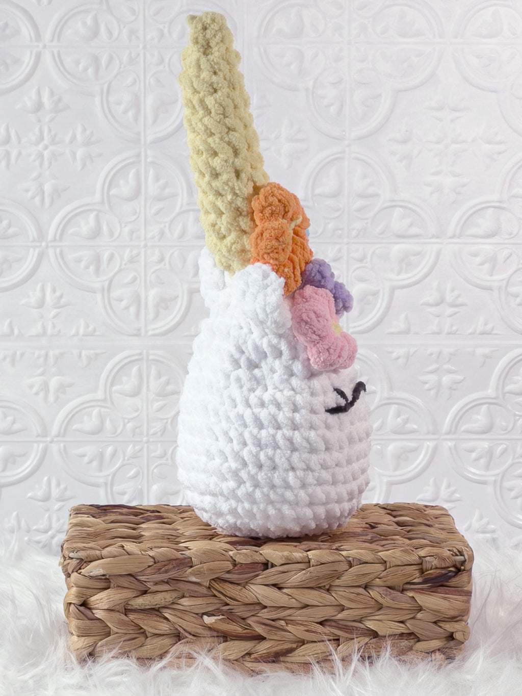 Handmade multicolor unicorn crochet plushie shown from the side