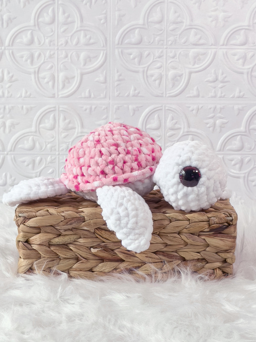 Handmade multicolor, pink turtle crochet plushie shown from an angled view