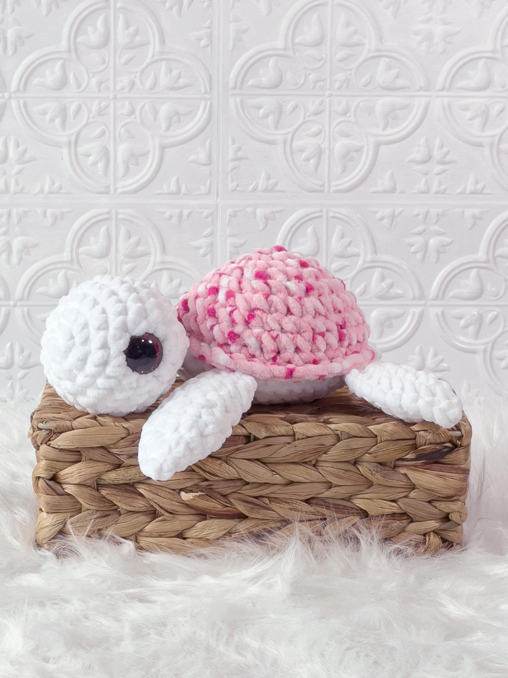 Handmade multicolor, pink turtle crochet plushie shown from the side