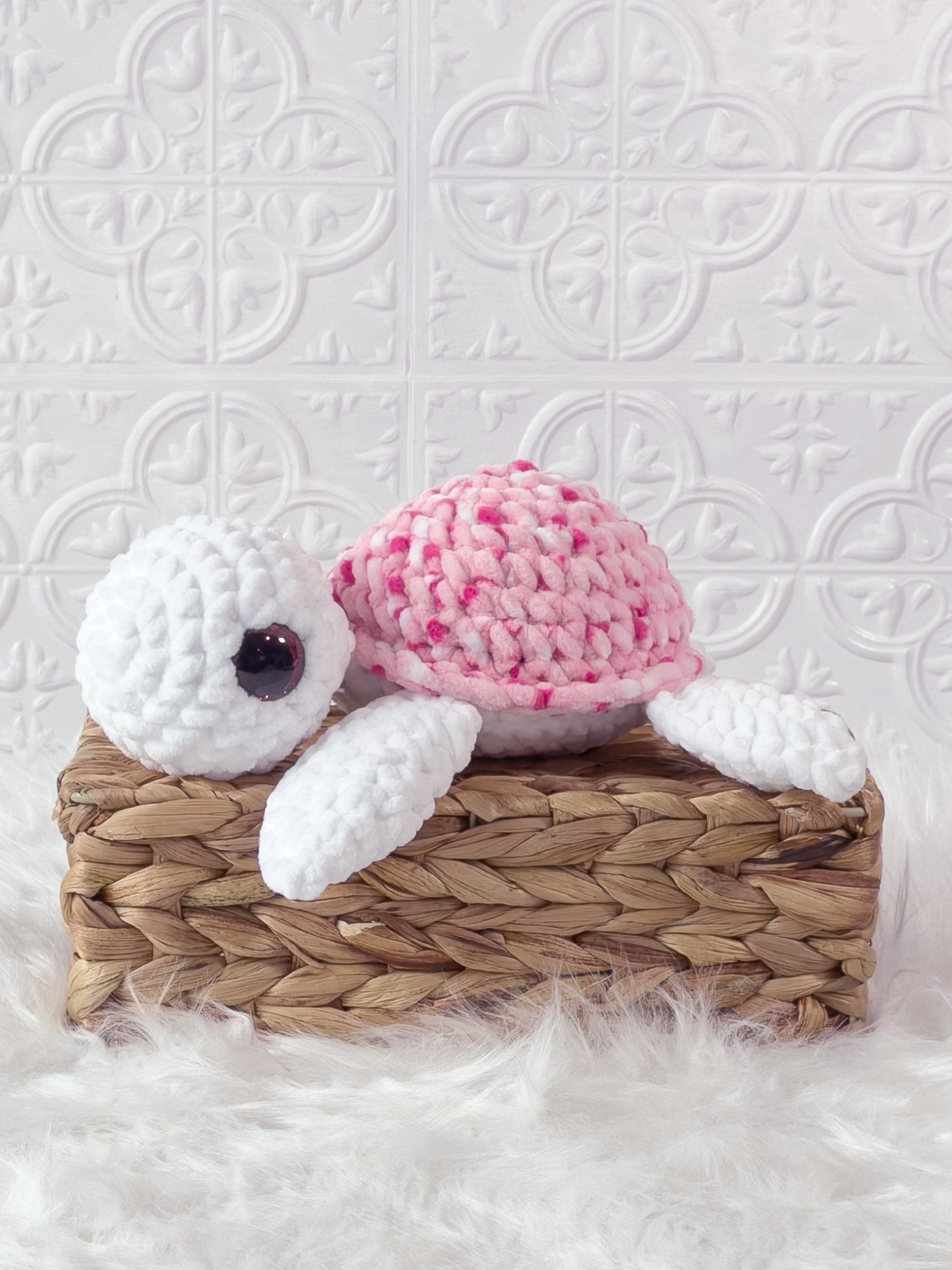 Handmade multicolor, pink turtle crochet plushie shown from the side
