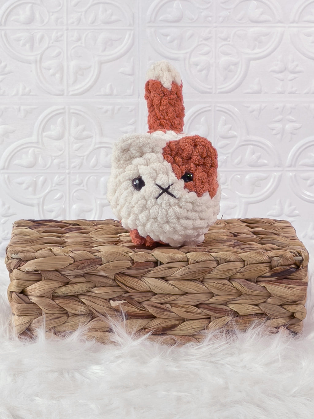 Handmade orange, cream loaf cat crochet plushie shown from the front