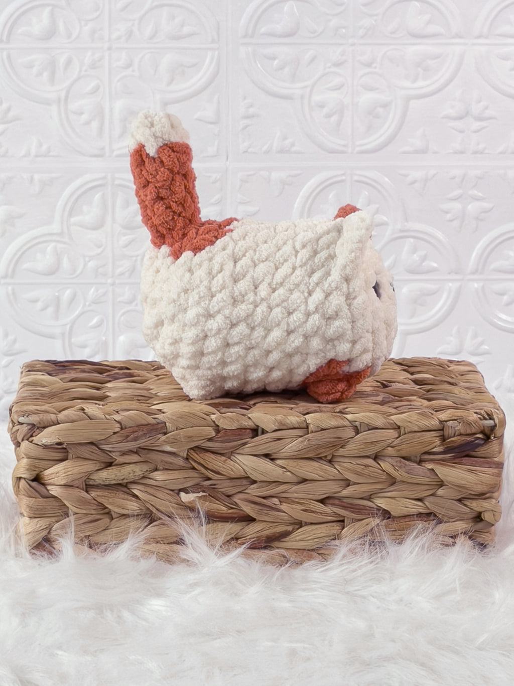 Handmade orange, cream loaf cat crochet plushie shown from the side