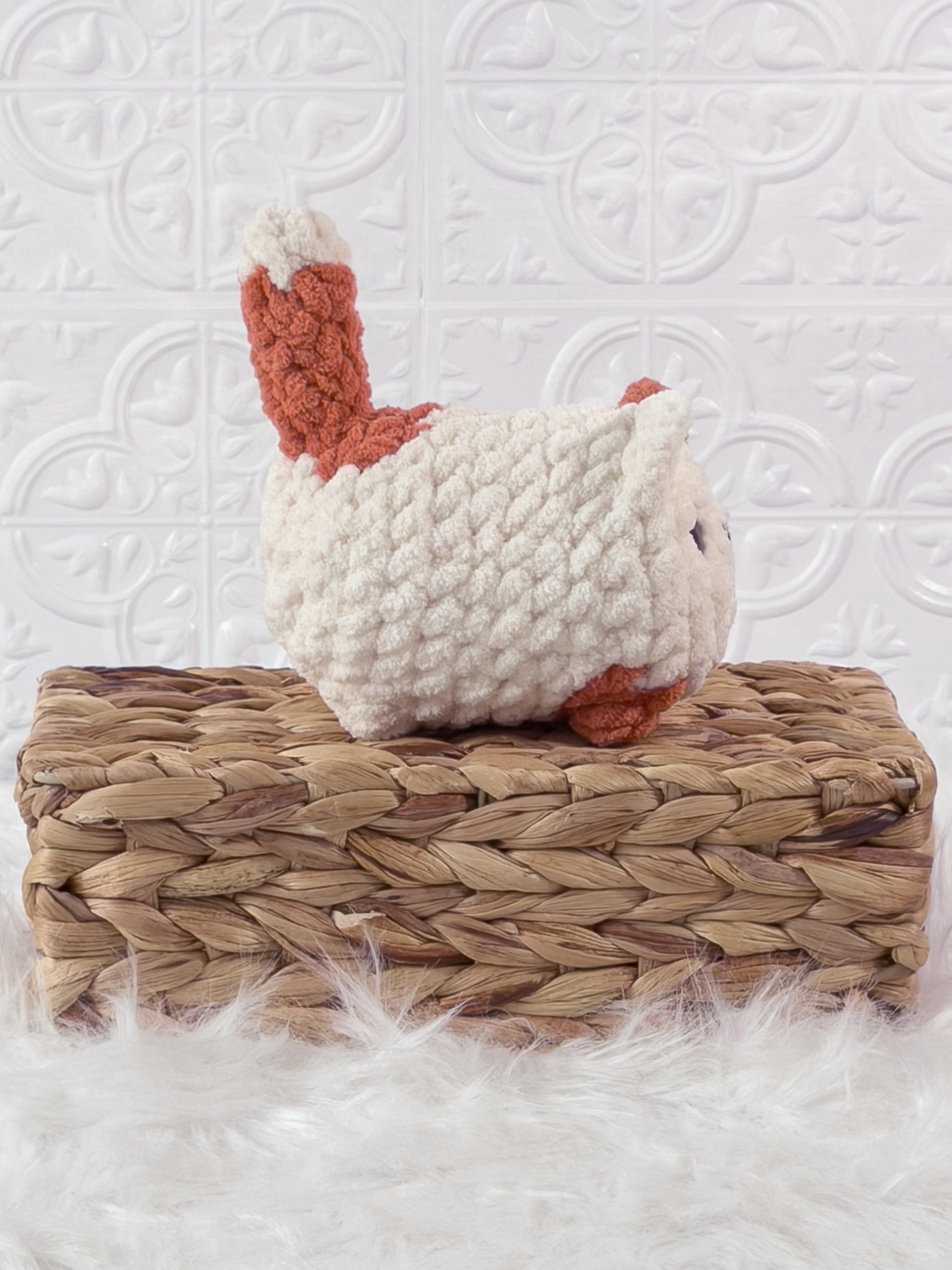 Handmade orange, cream loaf cat crochet plushie shown from the side