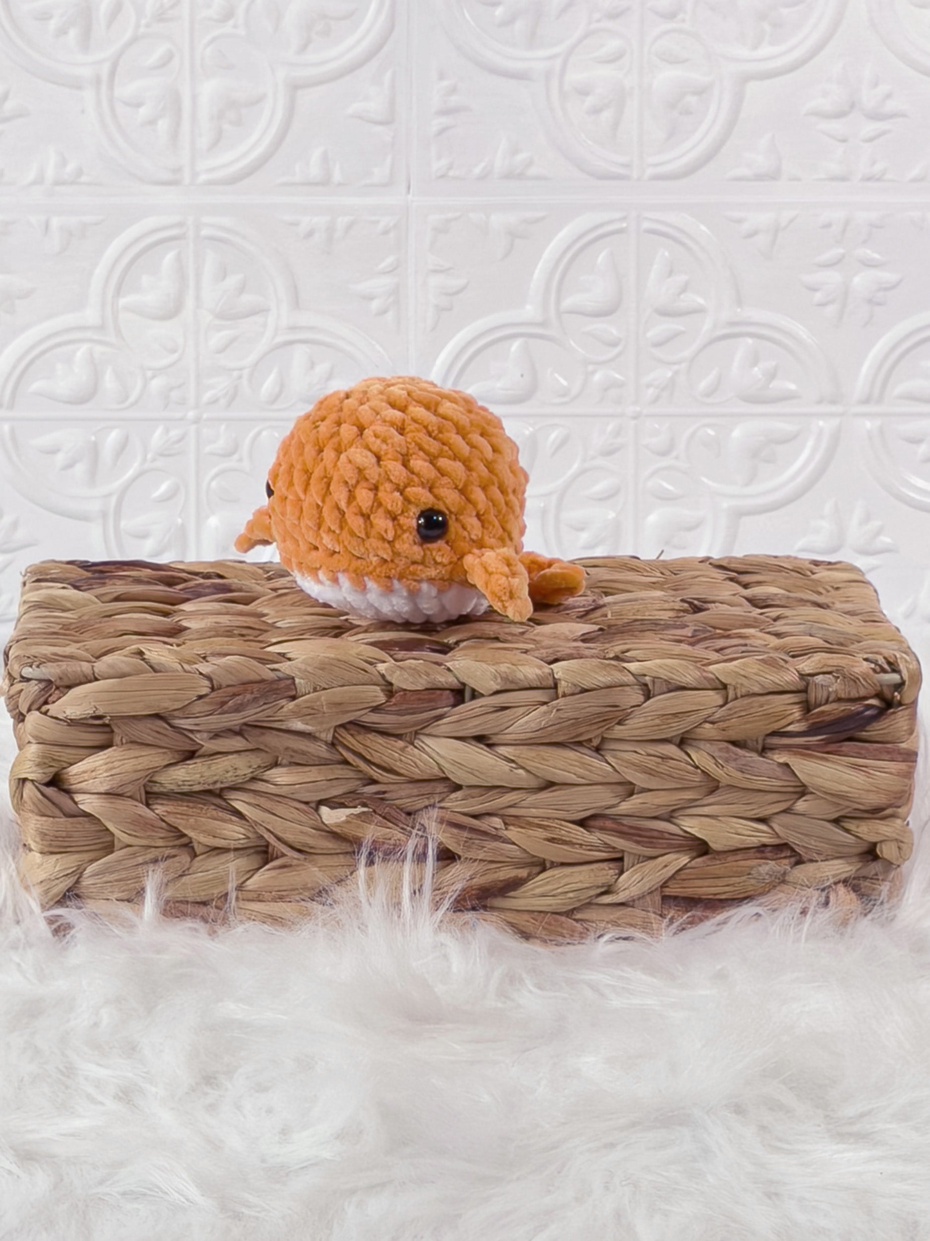 Small handmade whale crochet plushie shown from the front