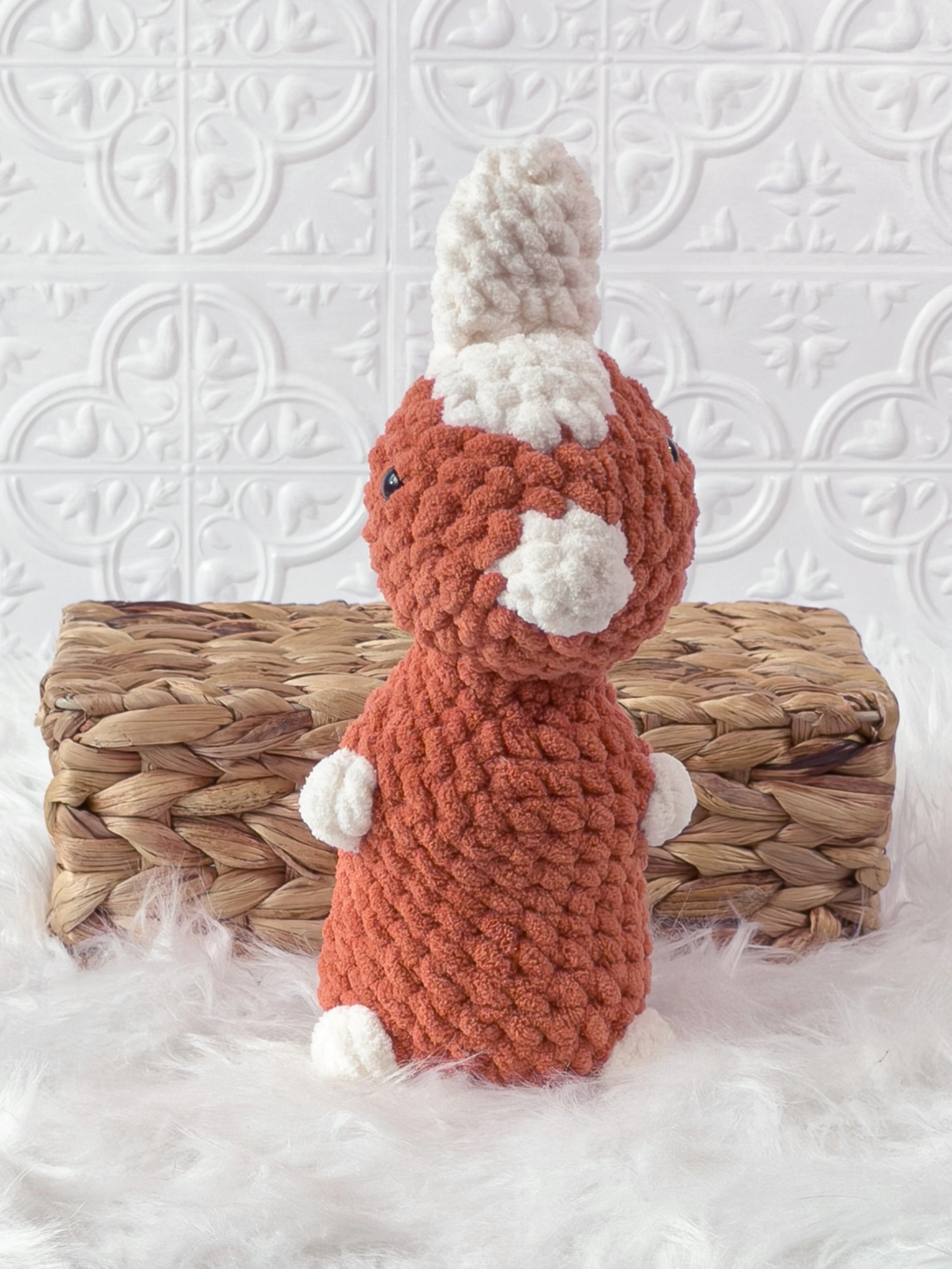 Handmade orange parasaurolophus crochet plushie shown from the front