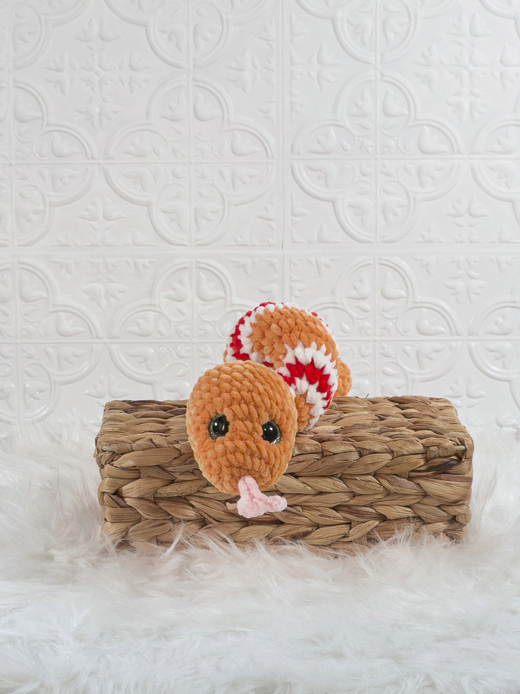 Handmade orange snake crochet plushie shown from the front