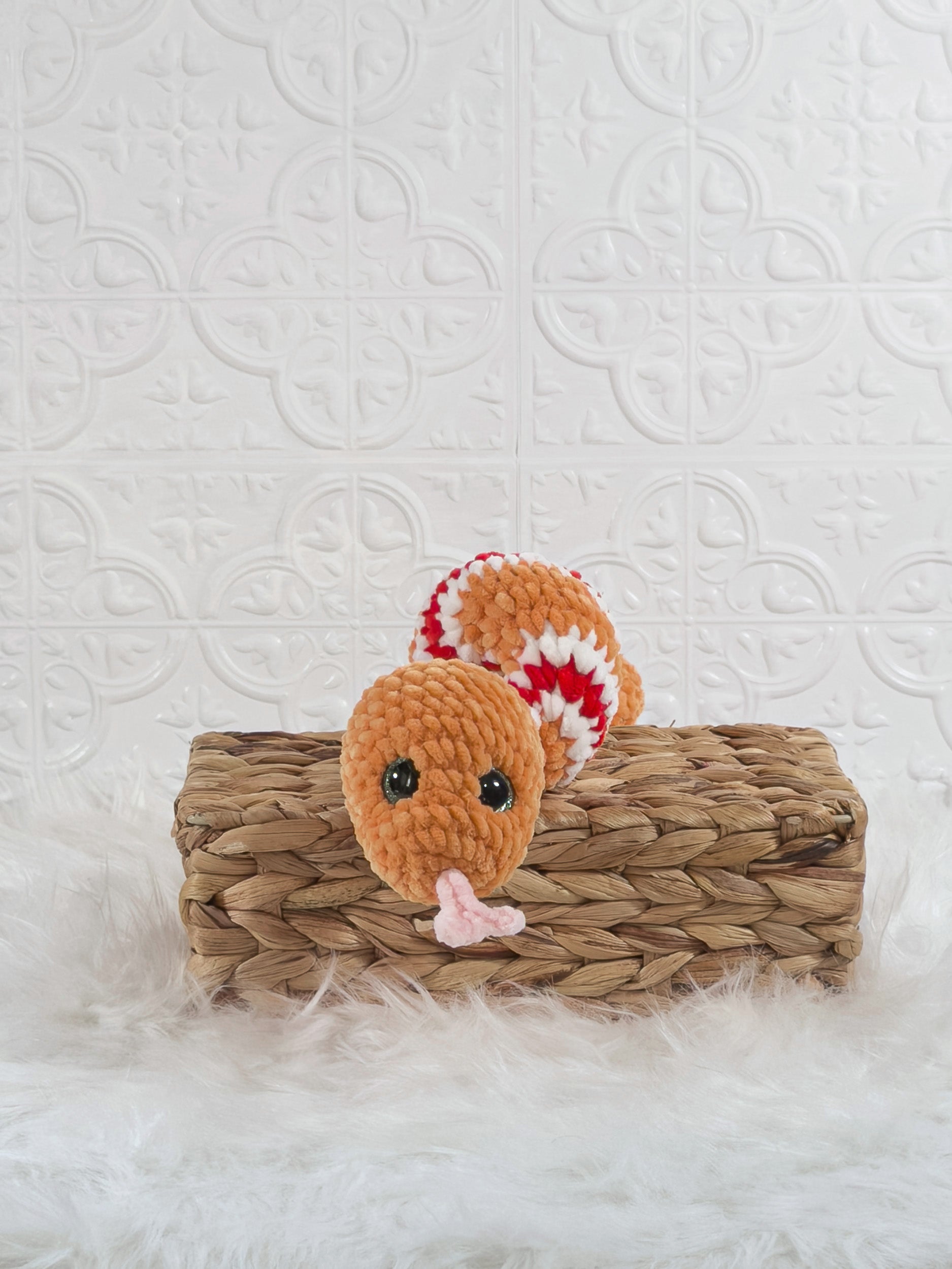 Handmade orange snake crochet plushie shown from the front