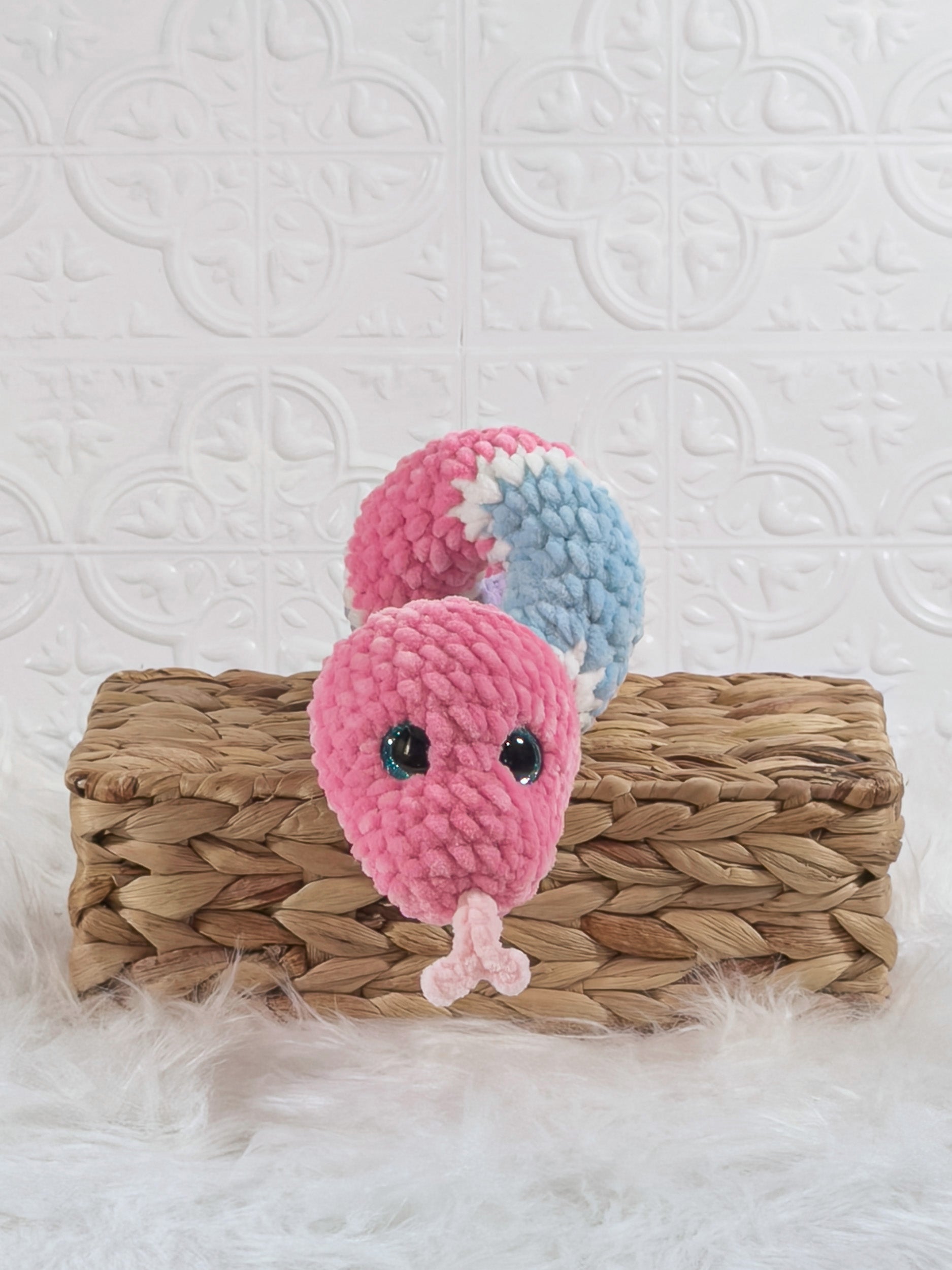 Handmade pink and blue snake crochet plushie shown from the front