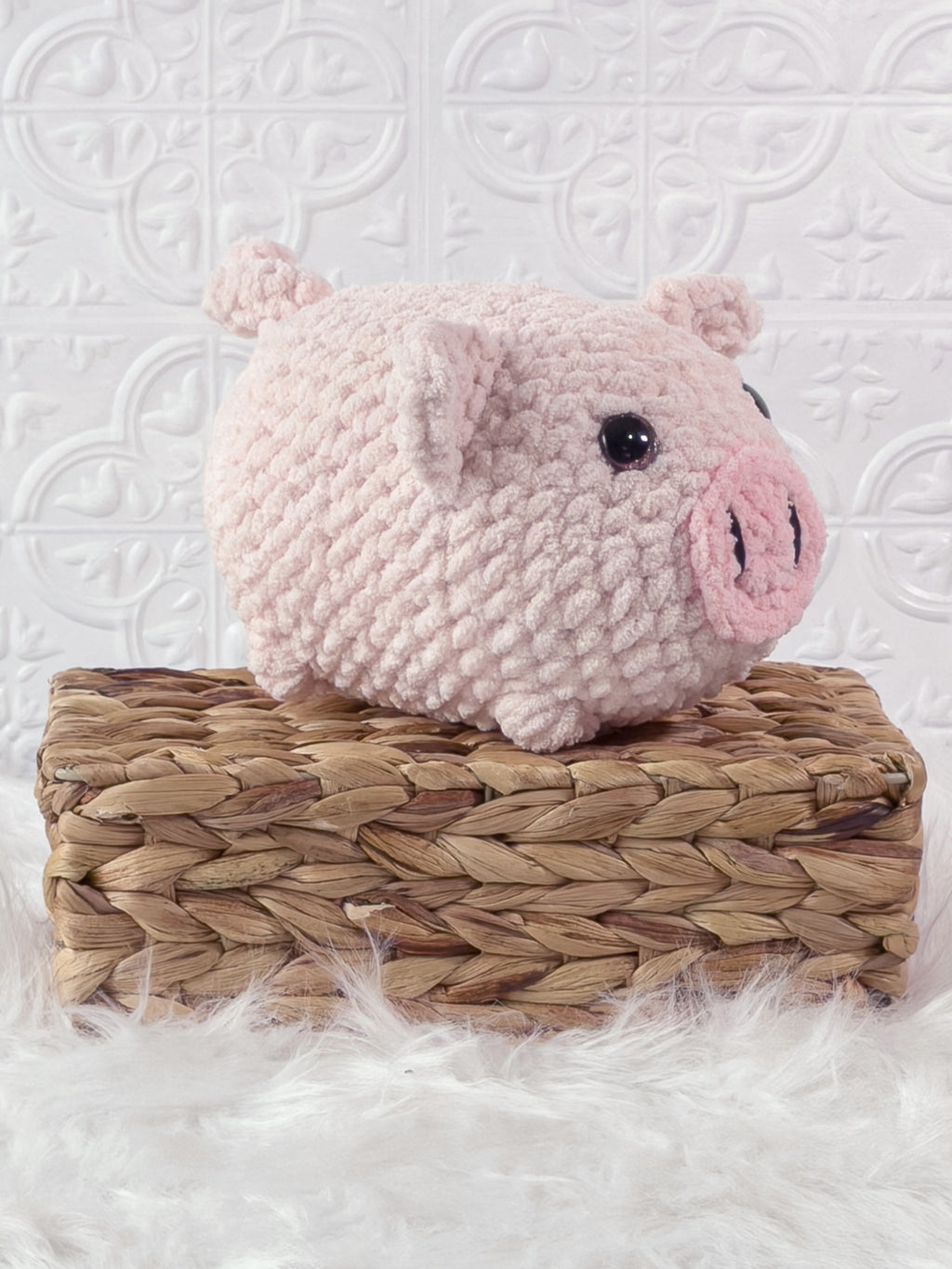 Handmade pink fat pig crochet plushie shown from an angled view