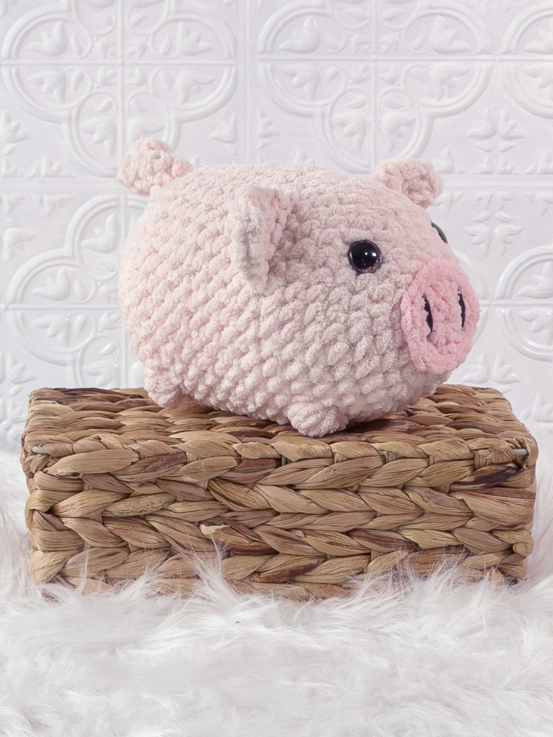 Handmade pink fat pig crochet plushie shown from an angled view