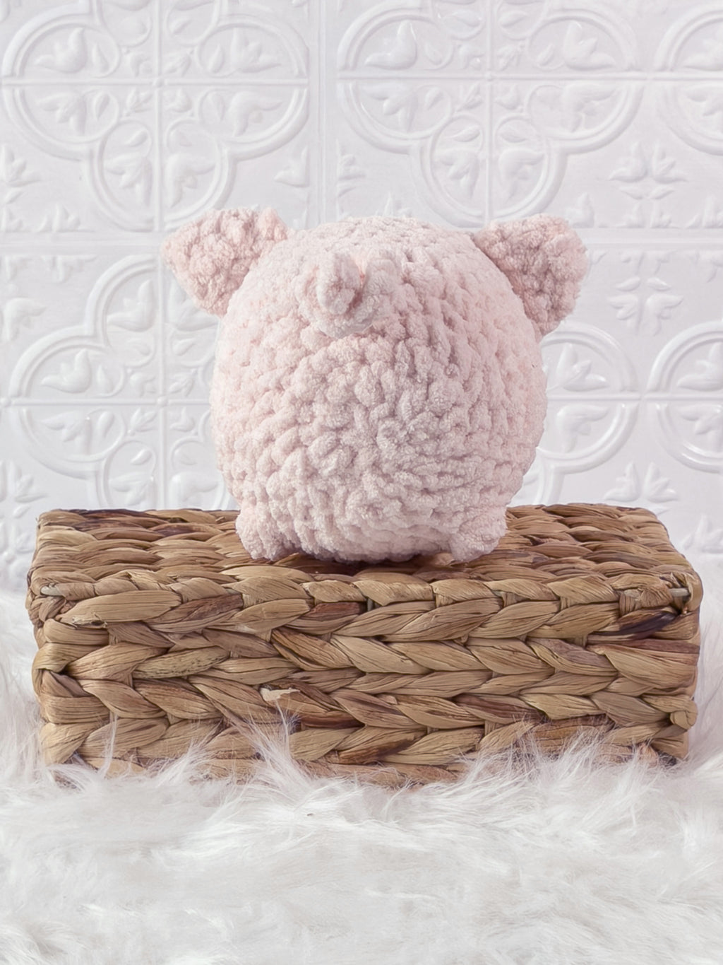 Handmade pink fat pig crochet plushie shown from the back