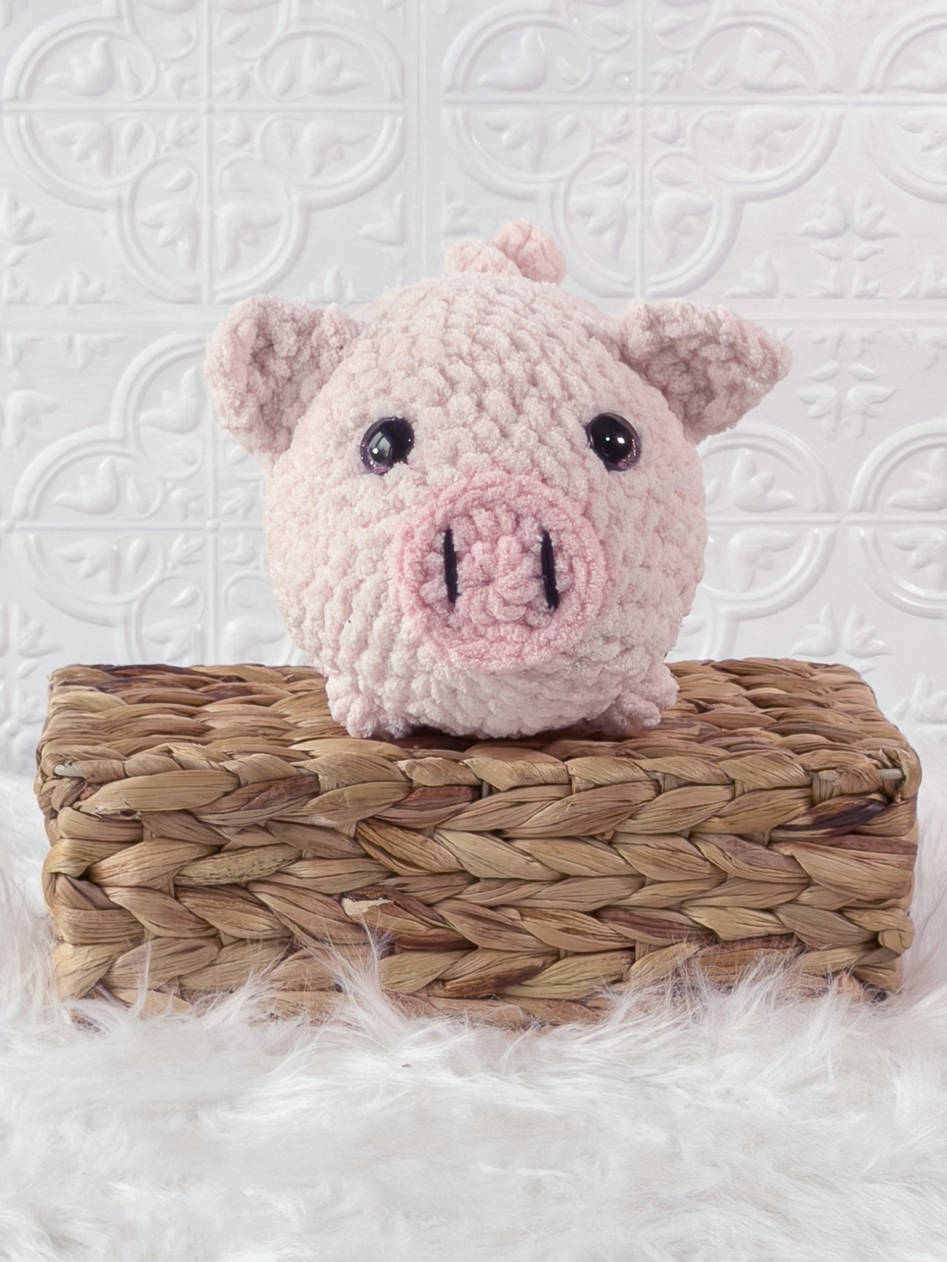 Handmade pink fat pig crochet plushie shown from the front