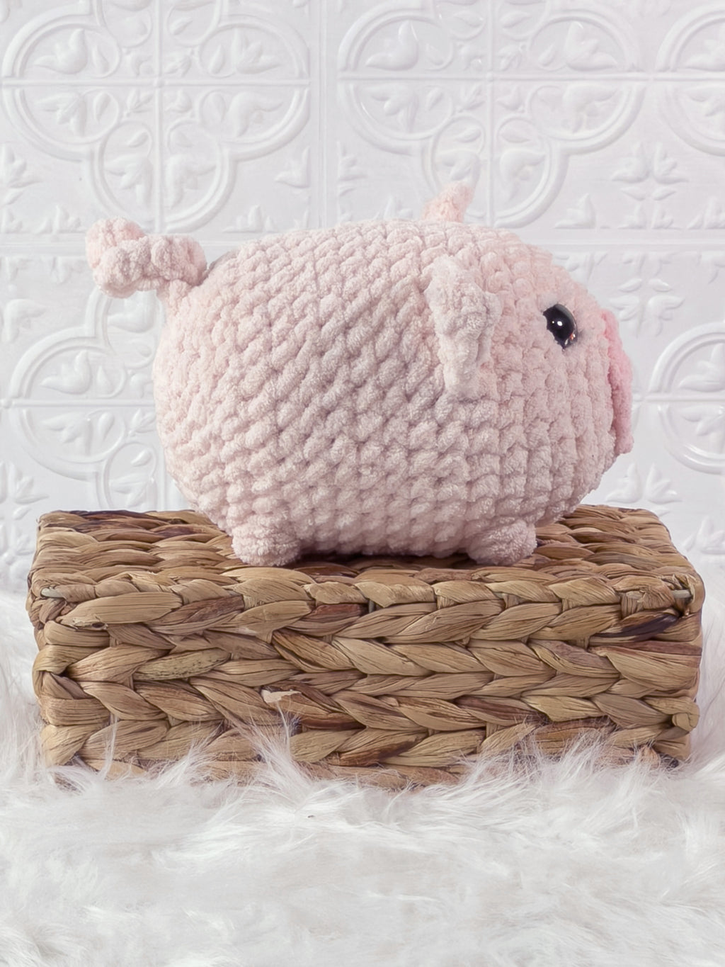 Handmade pink fat pig crochet plushie shown from the side