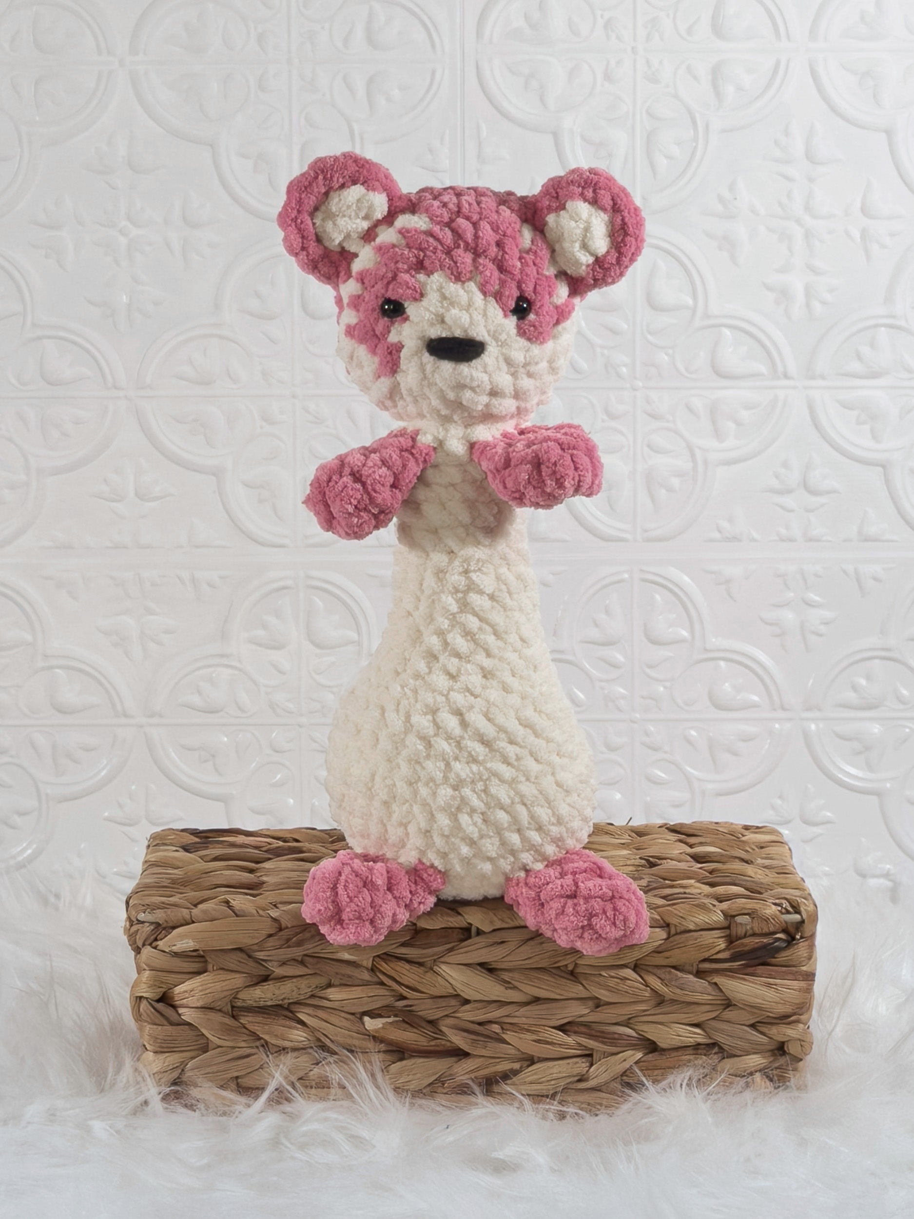 Handmade pink ferret crochet plushie shown from the front