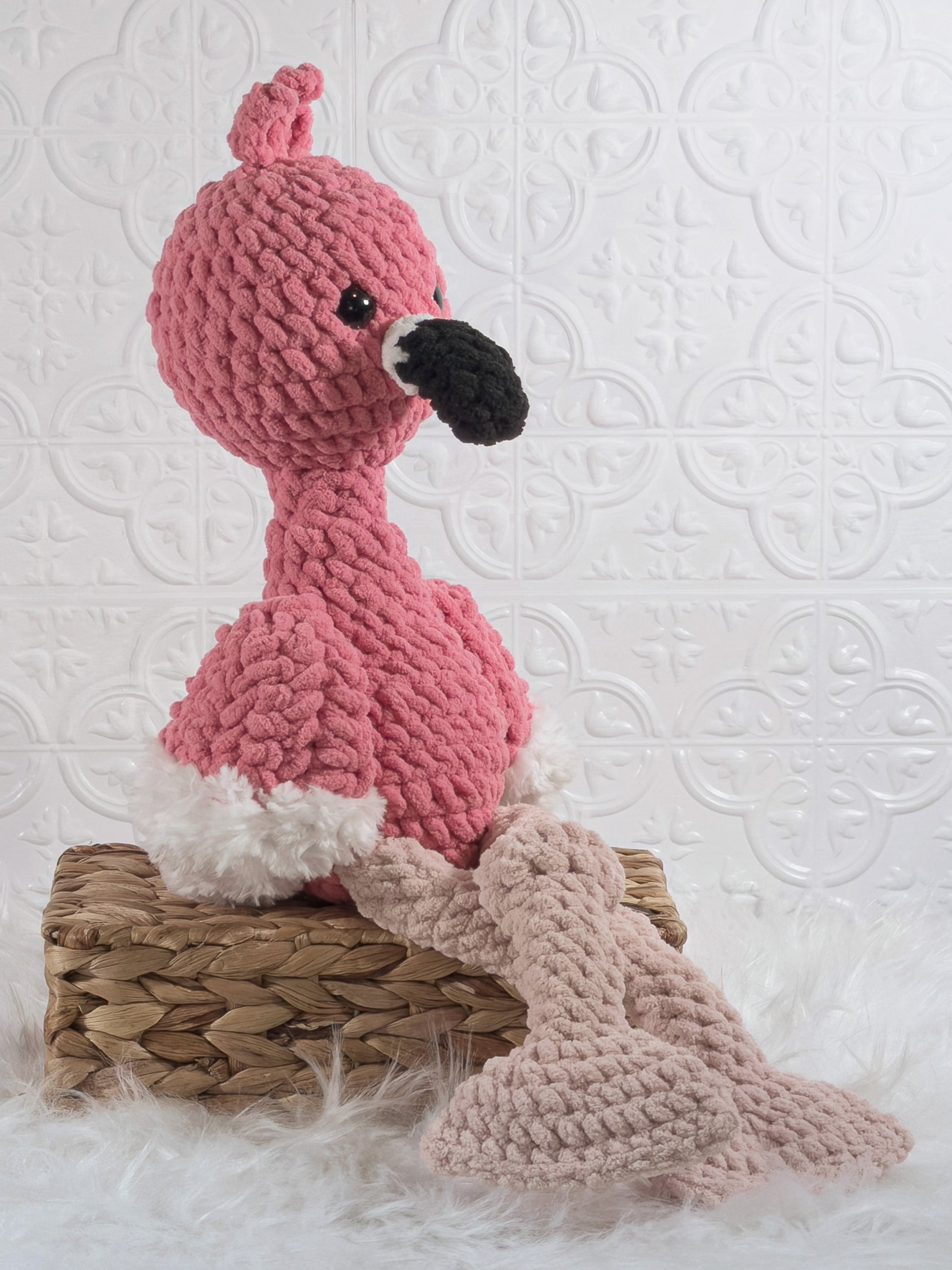Handmade pink flamingo crochet plushie shown from an angled view
