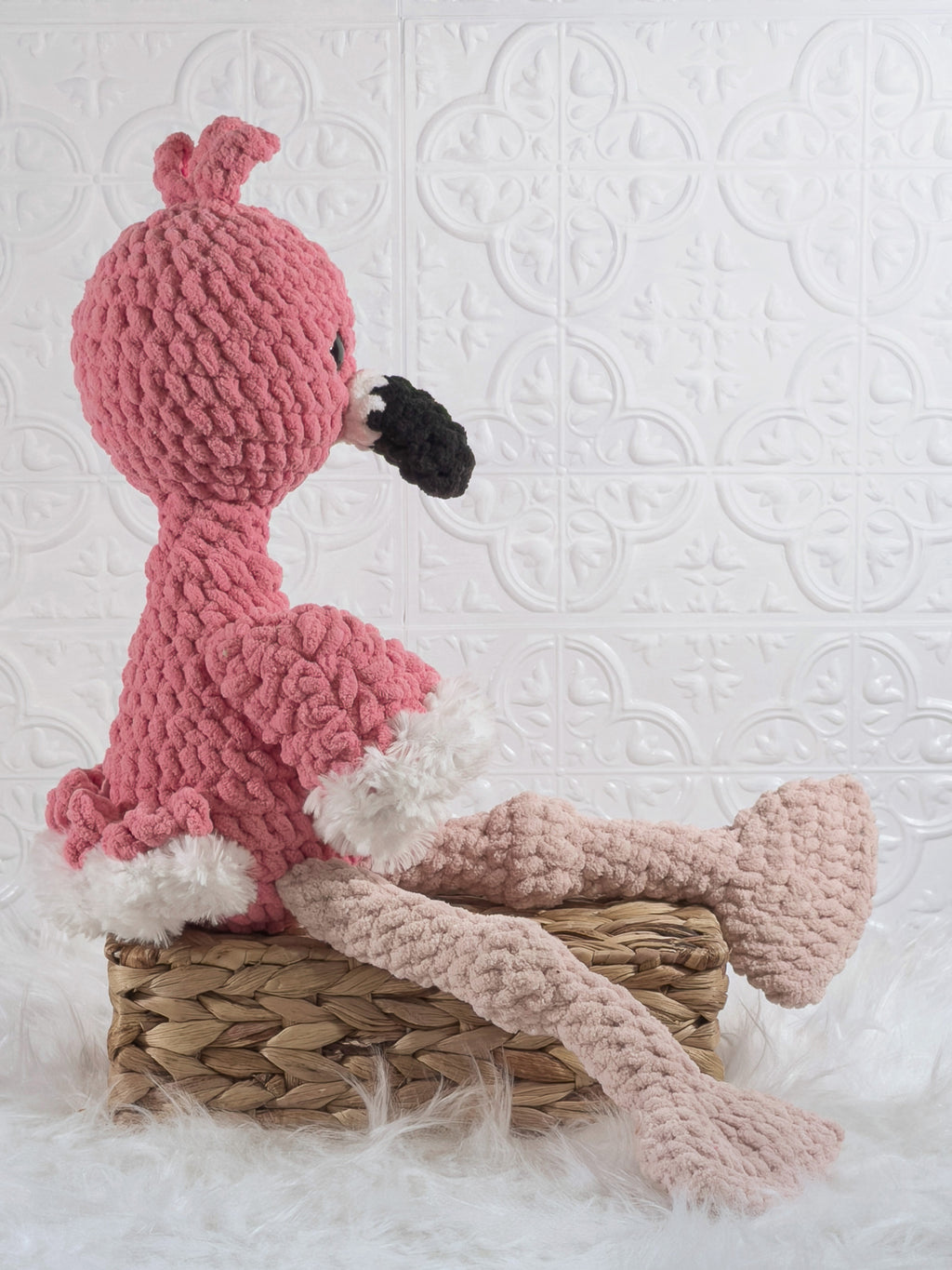 Handmade pink flamingo crochet plushie shown from the side