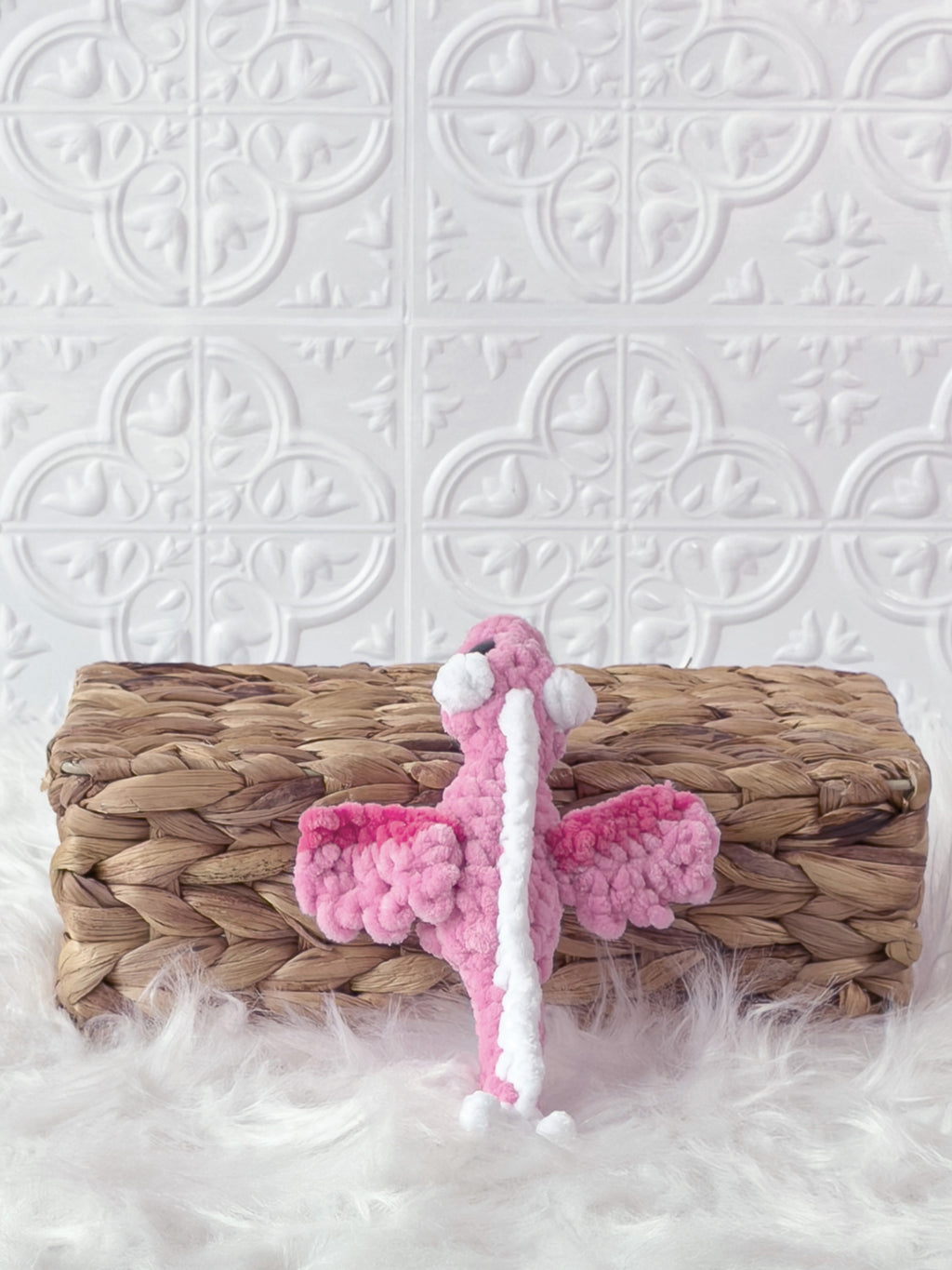 Handmade pink mini dragon crochet plushie shown from the back