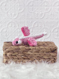 Small handmade dragon crochet plushie shown from the front